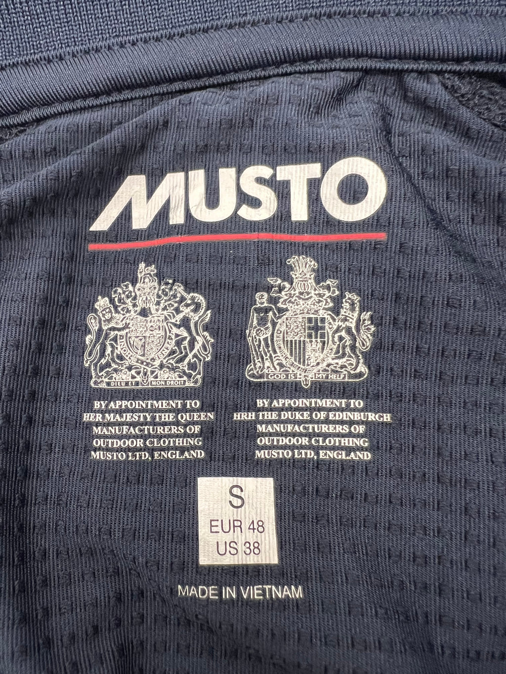 Interior label showing Musto branding, size small, and manufacturing details