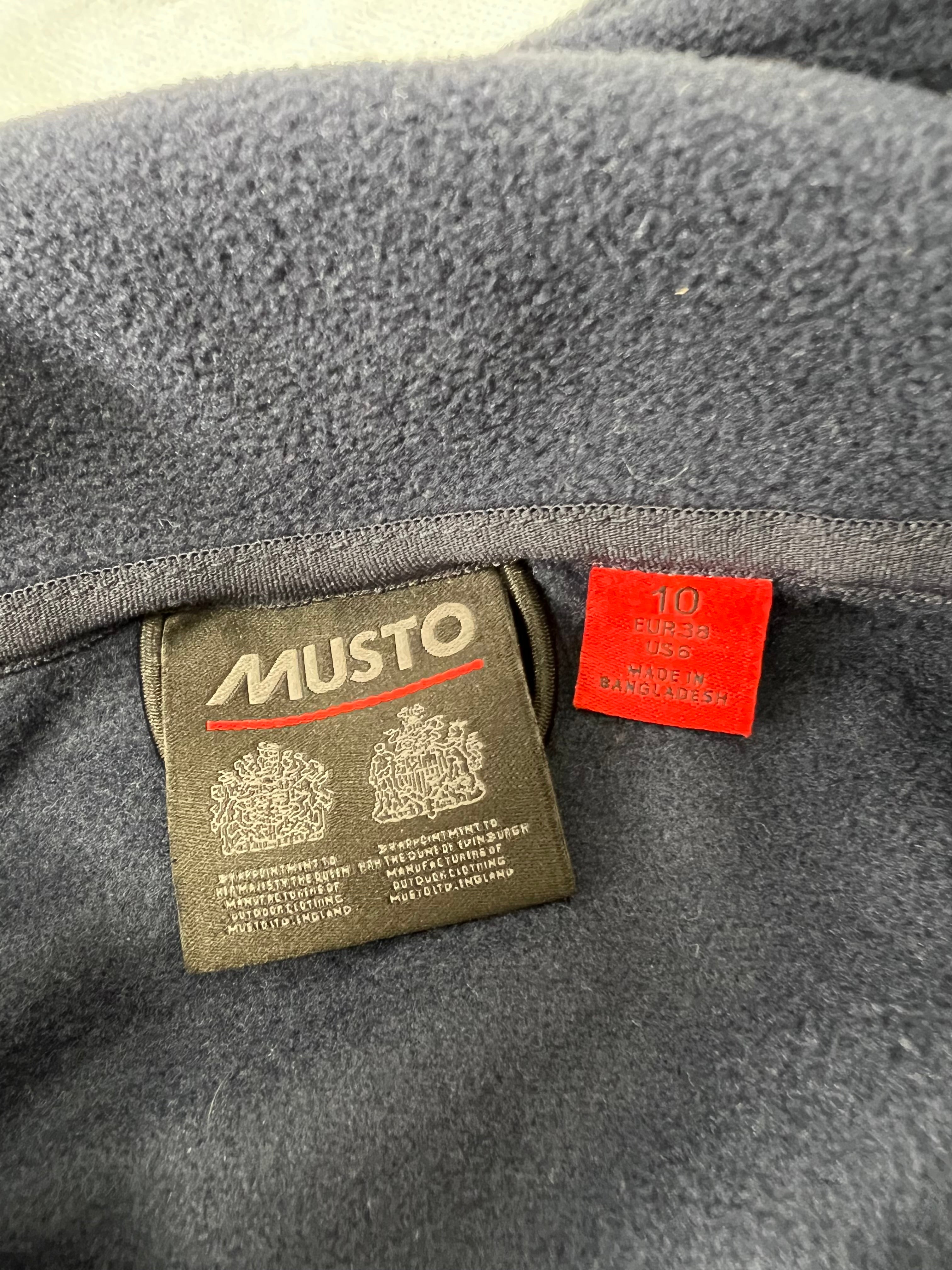 Inside label showing Musto brand and size 10 tag in navy fleece