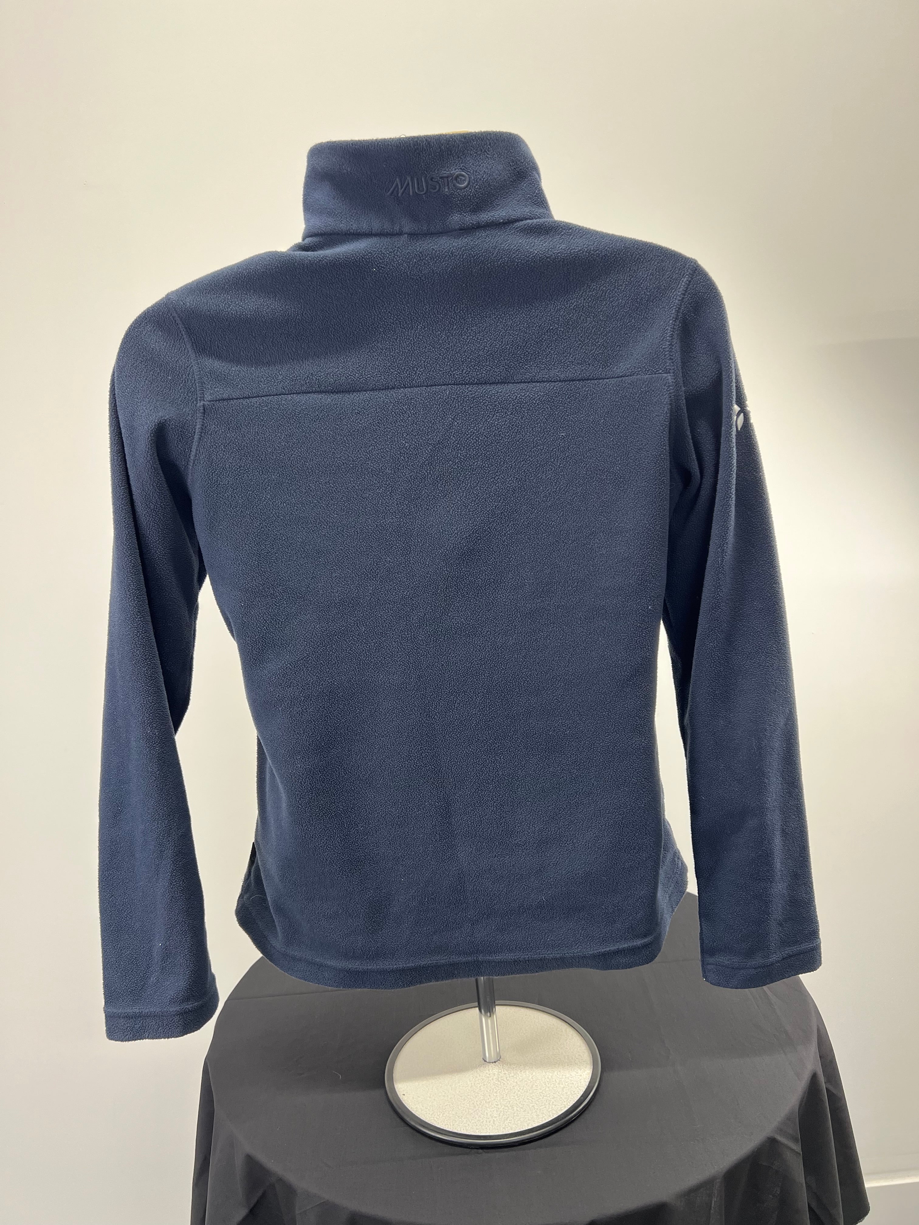 Back view of navy Musto fleece with plain fleece fabric and high collar
