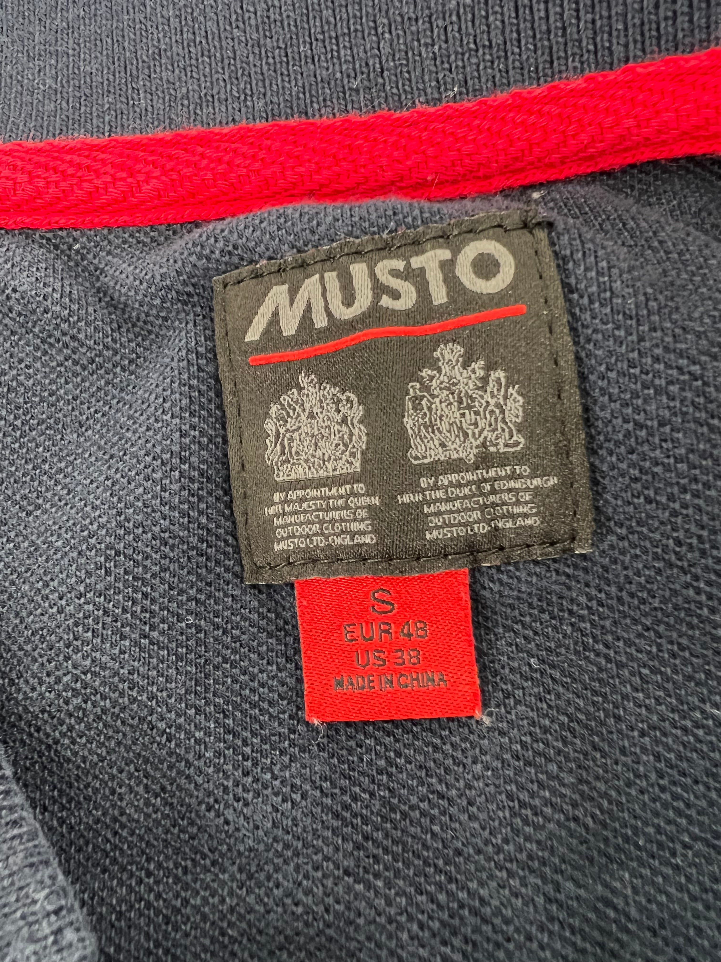 Close-up of interior label on Musto polo shirt showing brand and size S details
