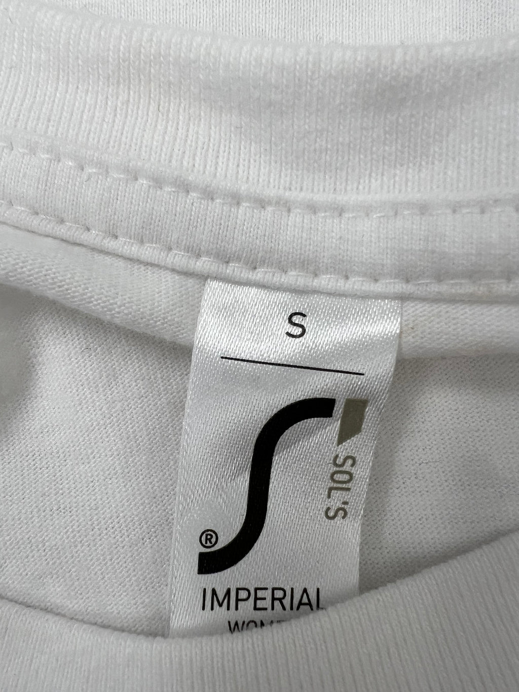 Close-up of the white t-shirt collar label showing size small by SOL'S Imperial brand