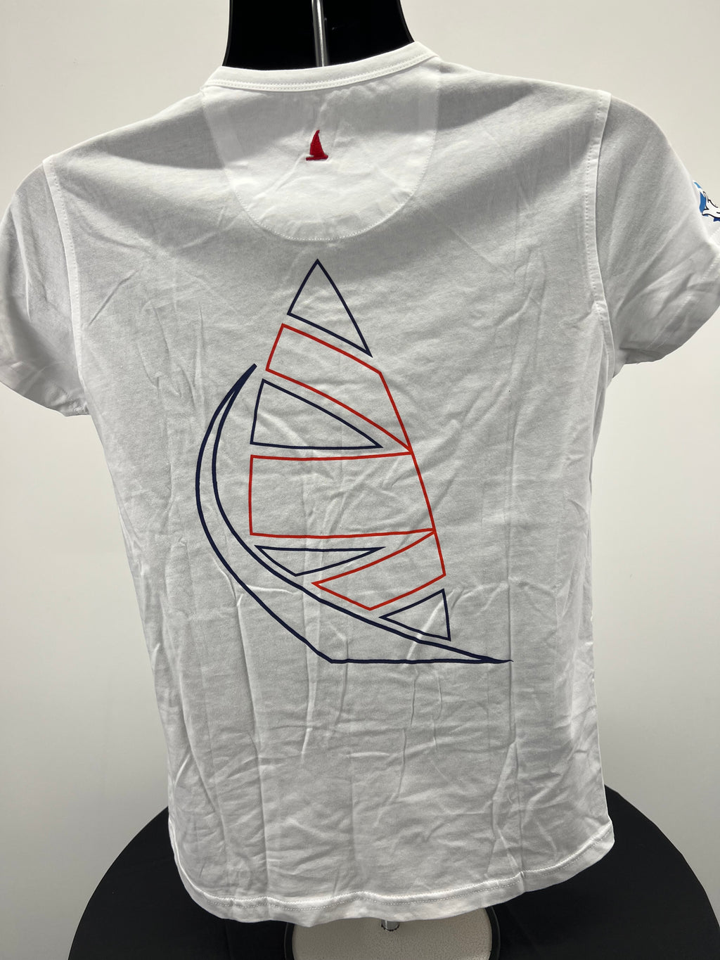 Back view of white Musto British Sailing Team t-shirt showing large stylised sail graphic in red and navy blue