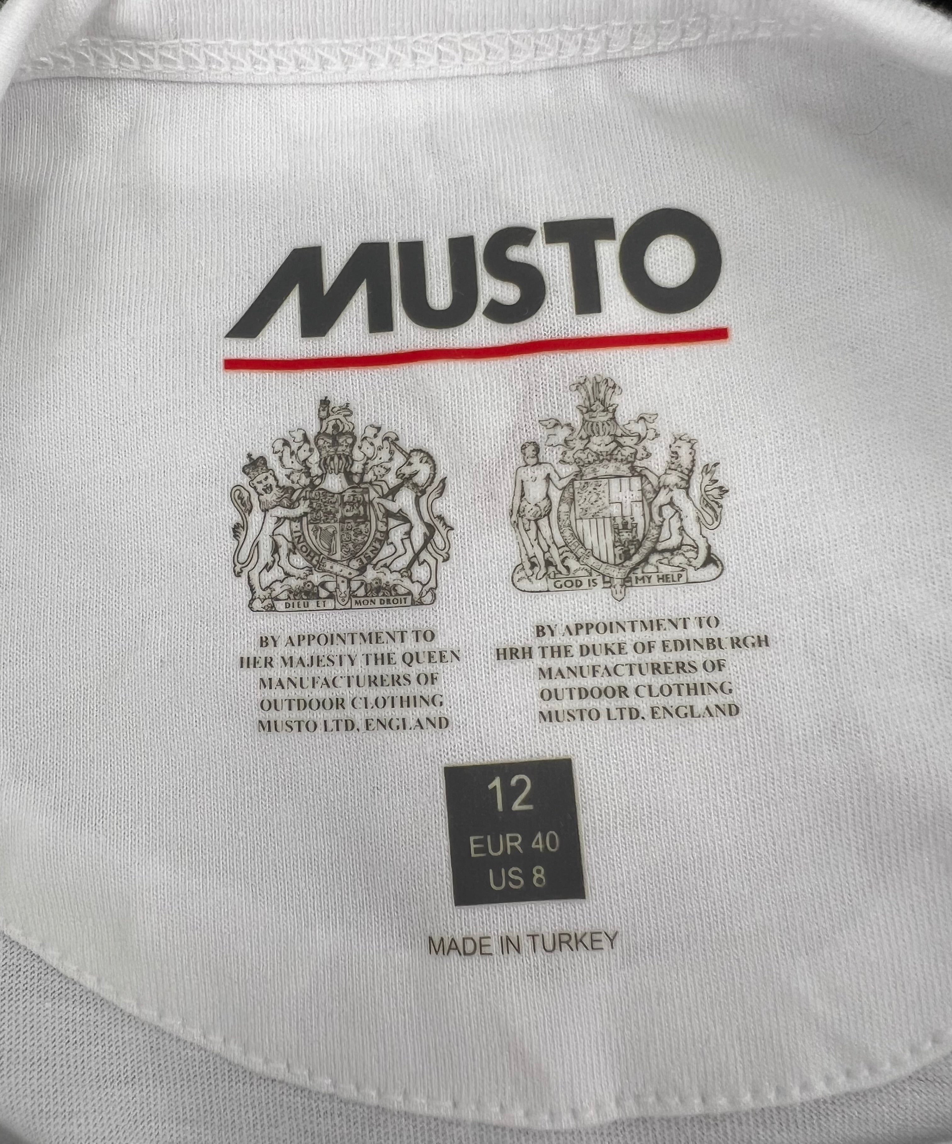Inside neck label of Musto t-shirt with brand logo, royal warrants, size 12 EUR 40 US 8, and 'Made in Turkey' text