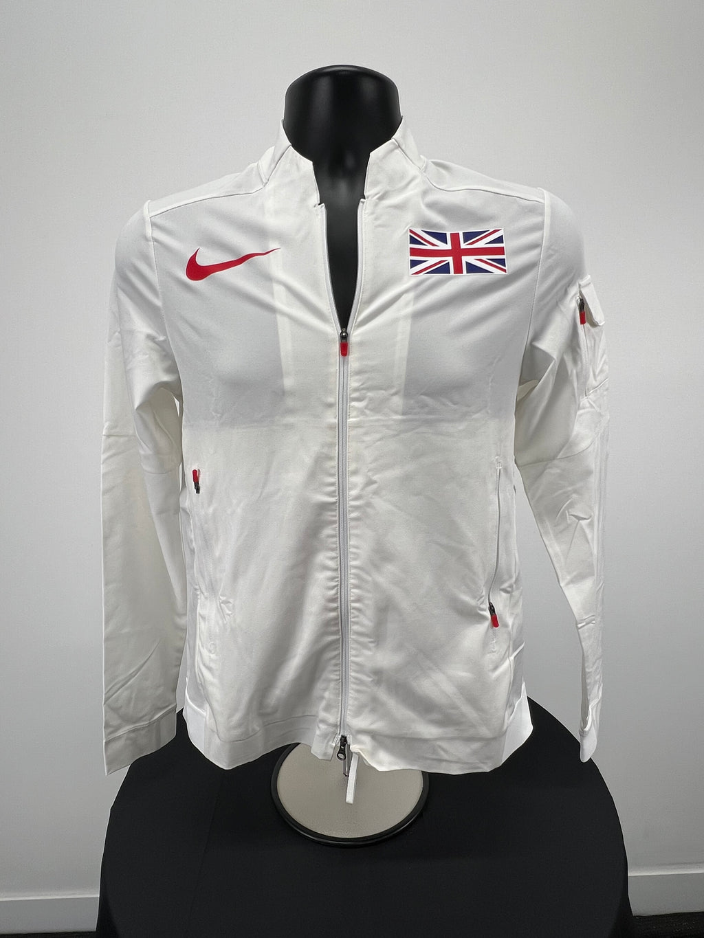 Front view of Nike Great Britain zip-up jacket in cream with Union Jack flag and red Nike swoosh