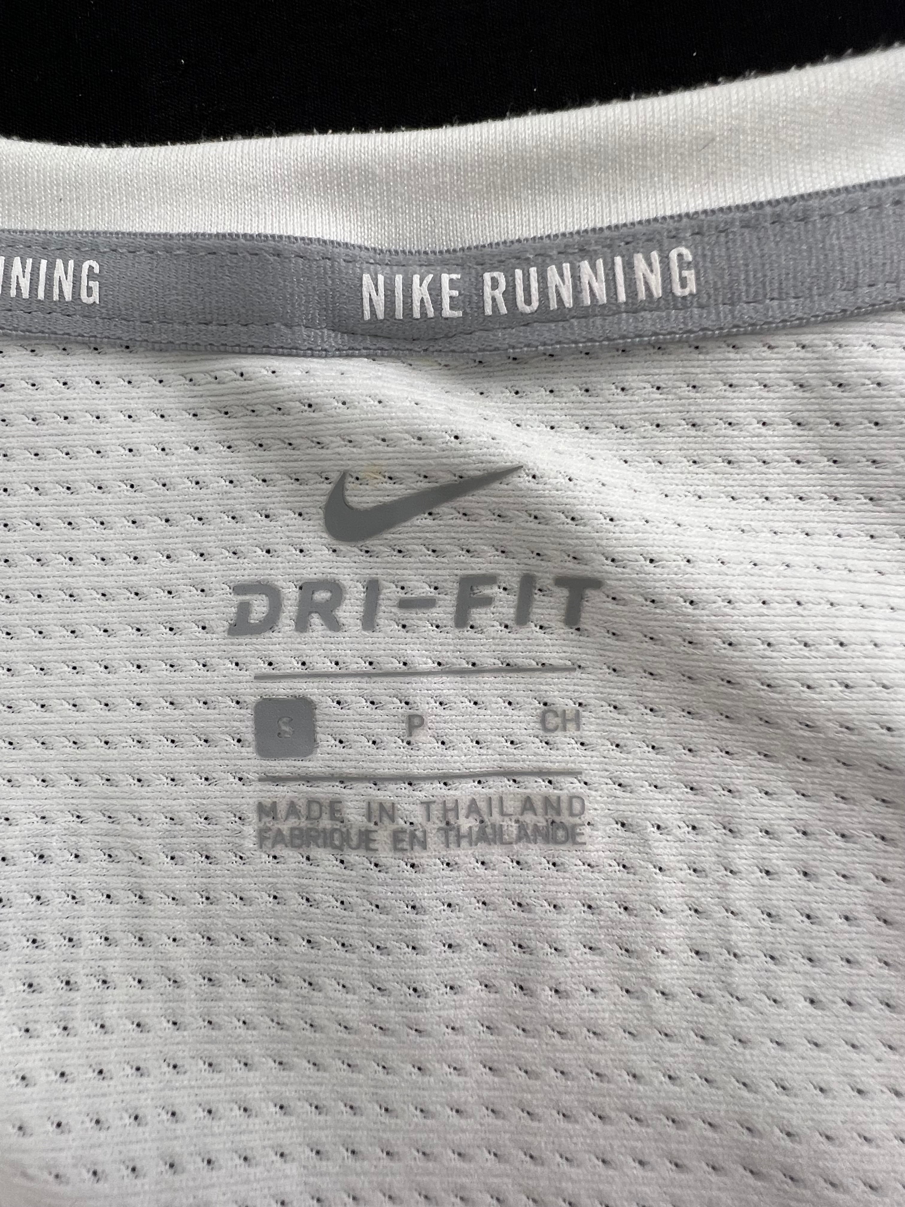 Close-up inside label of Nike Dri-FIT running t-shirt showing size and manufacturing details