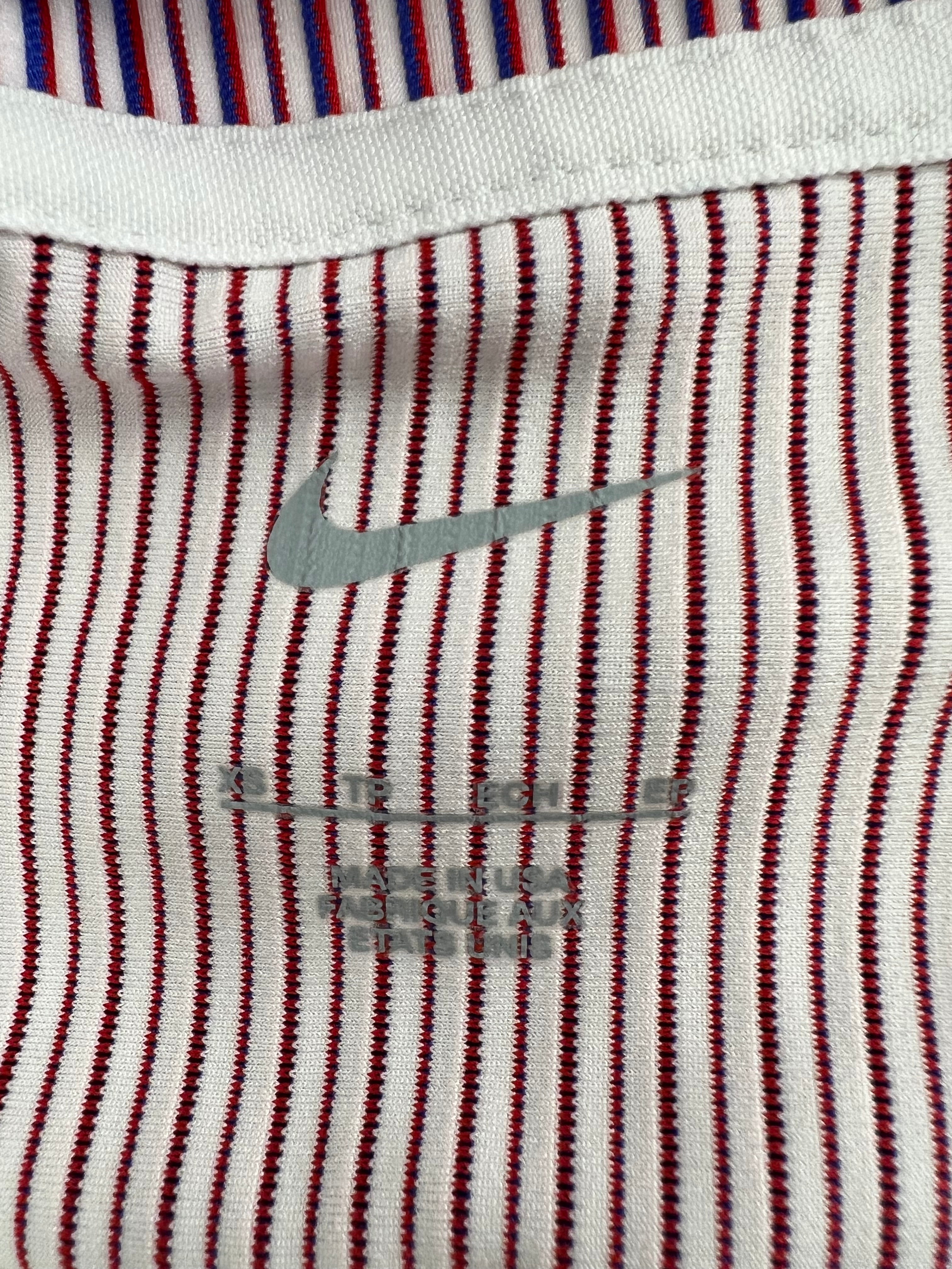 Close-up of Nike swoosh on striped fabric with fabric details printed below