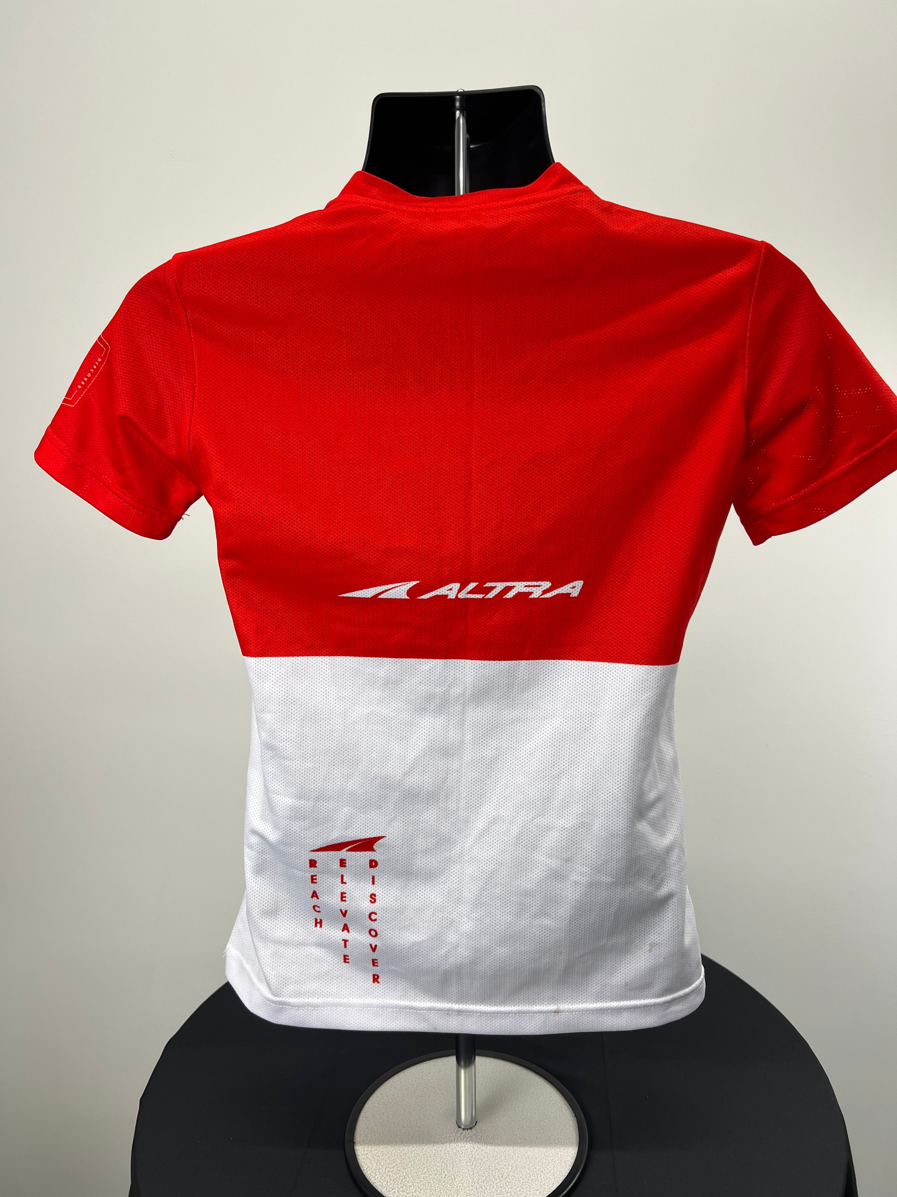 Back view of Altra women's red and white t-shirt showing logo and breathable mesh design