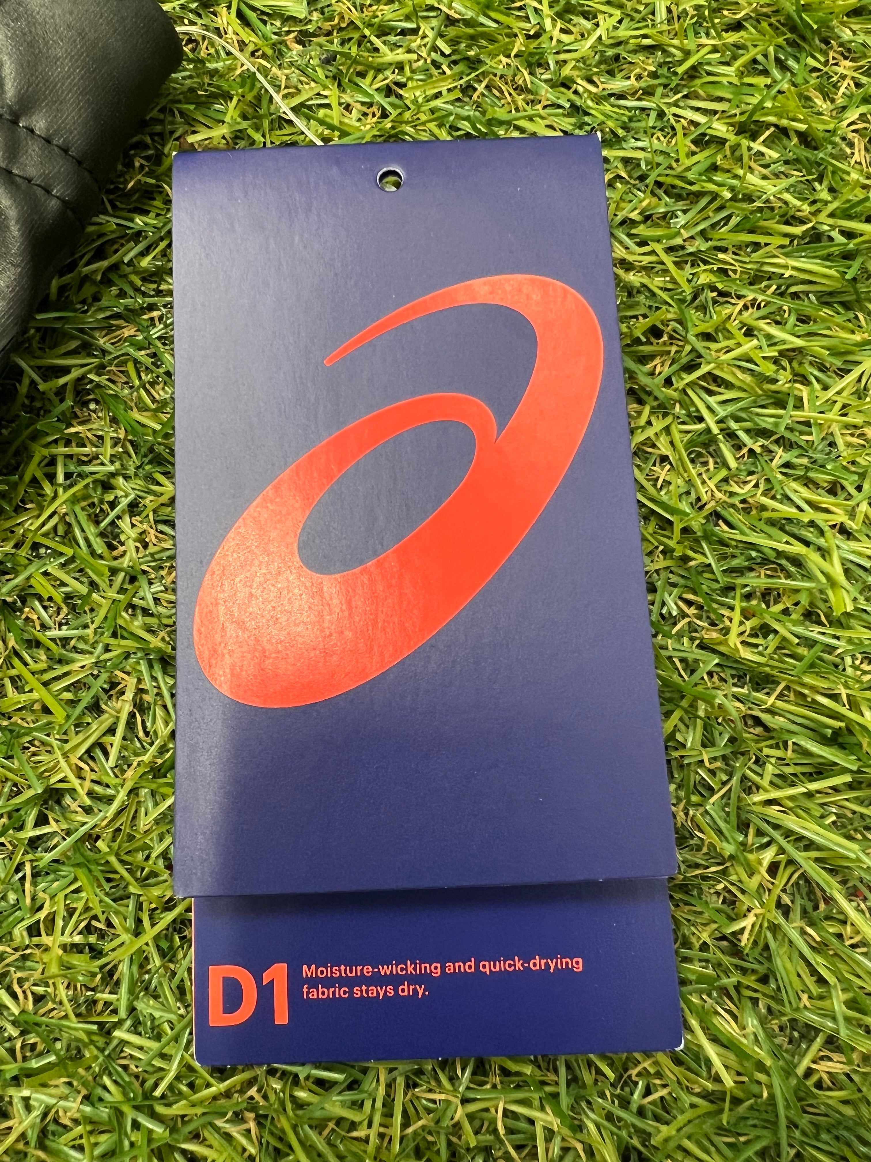 Detailed shot of ASICS product tag with brand logo and info about moisture-wicking quick-dry D1 fabric technology