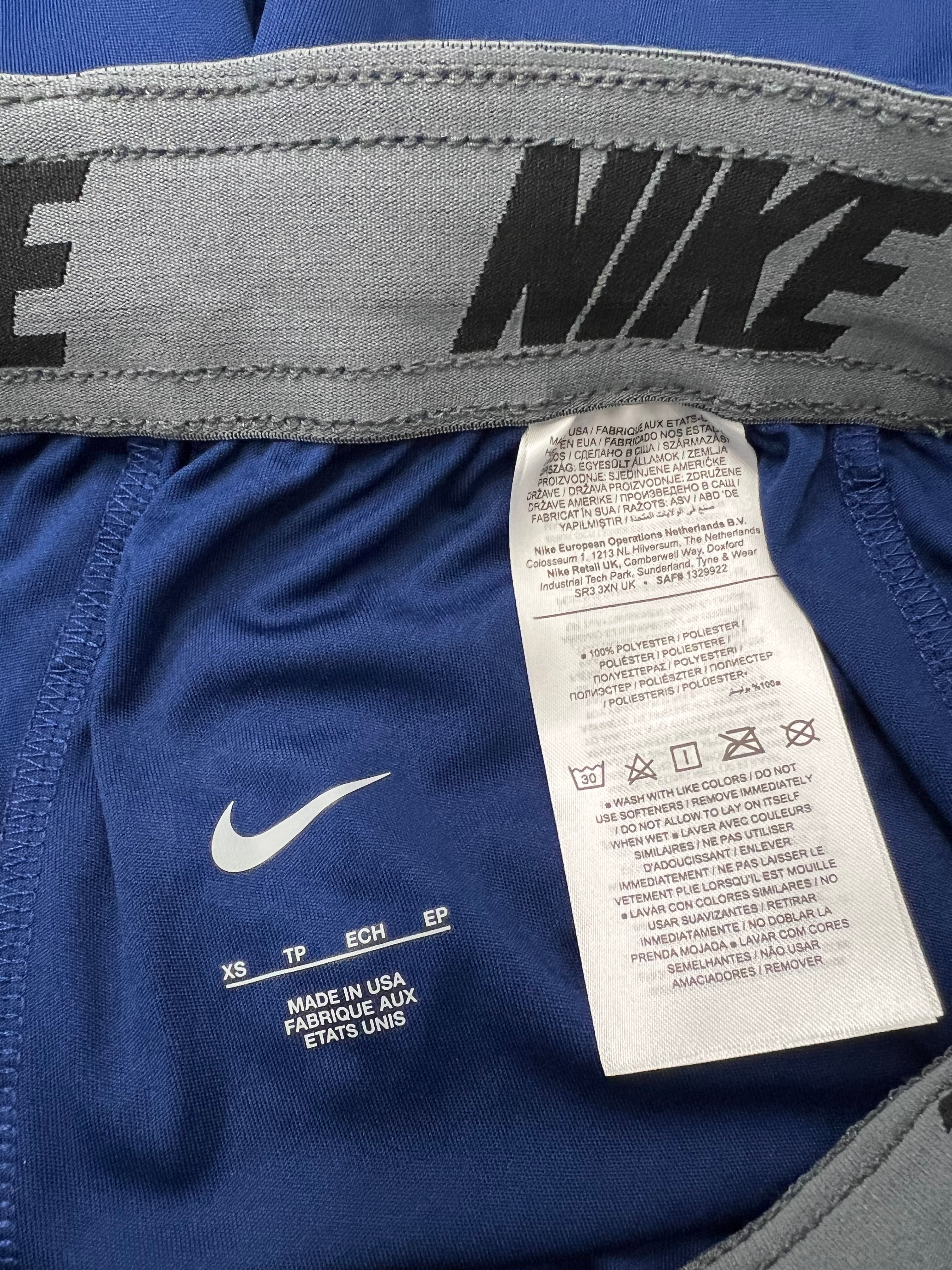 Close-up of the interior waistband and care label detailing 100% polyester and made in USA