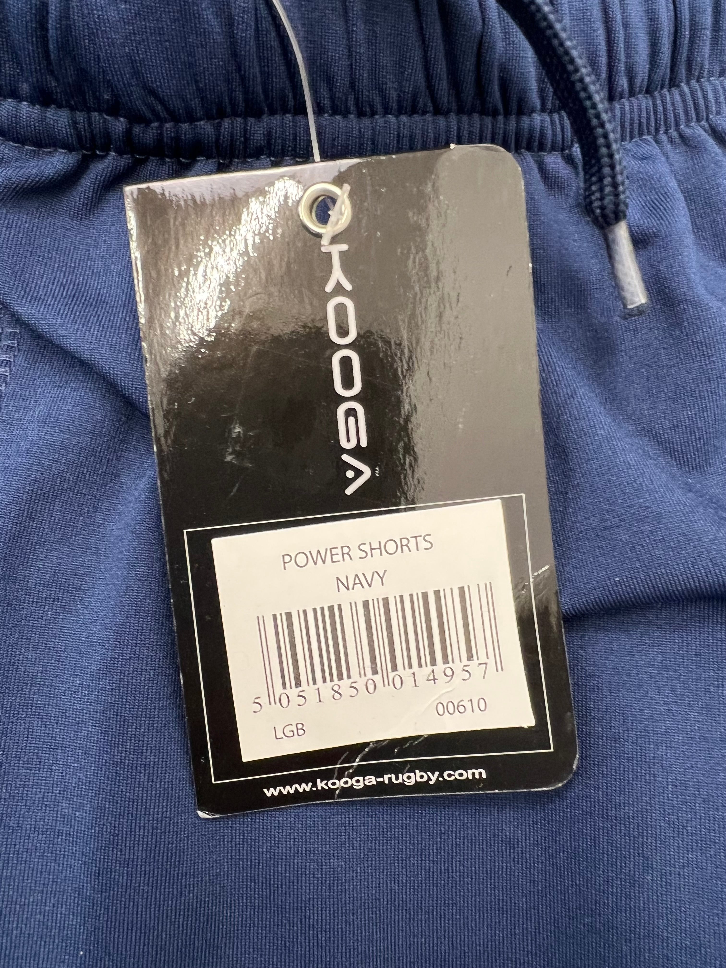 Close-up of Kooga Power Shorts label tag in navy with product details and barcode