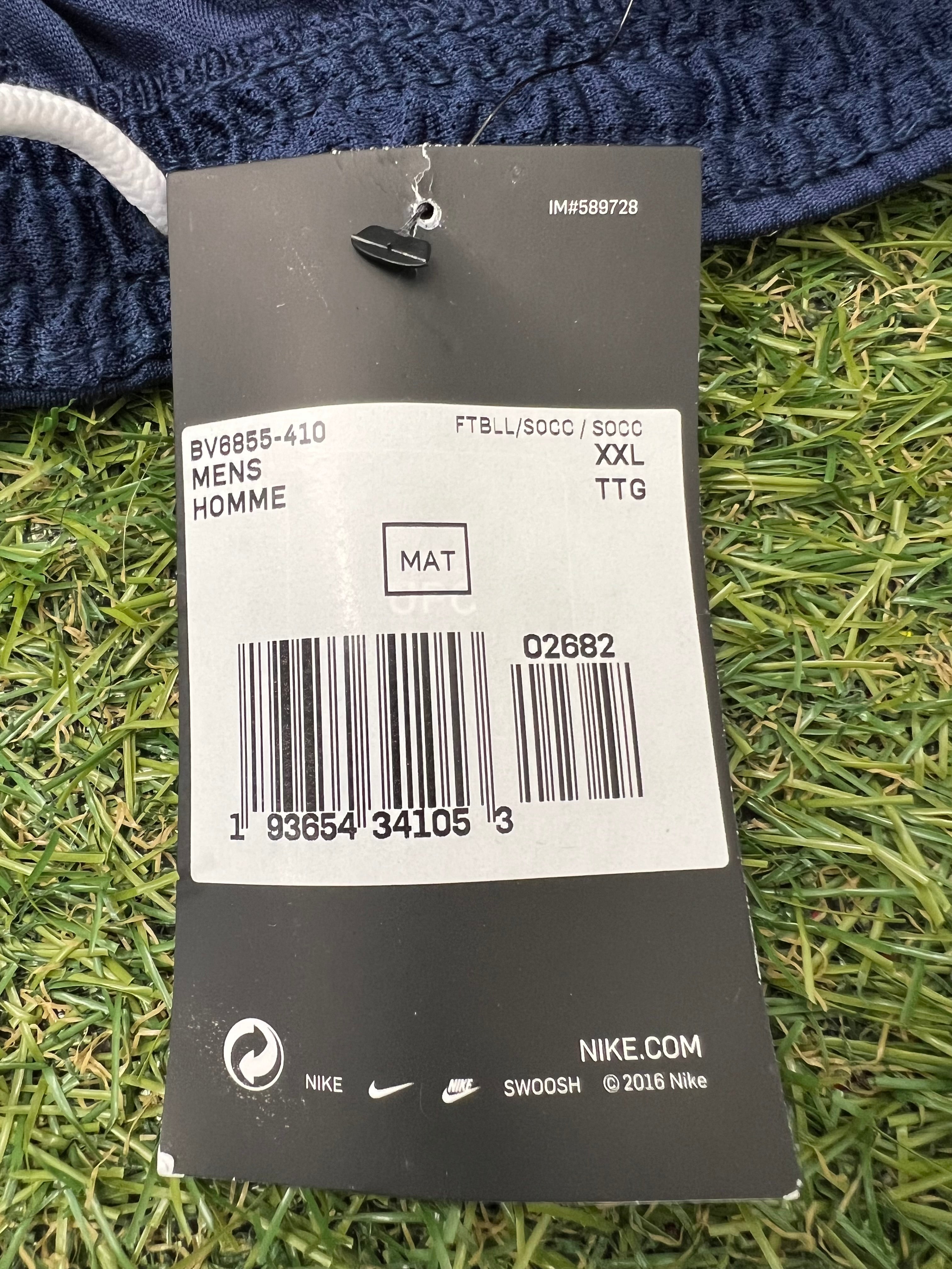 Nike product tag showing size XXL and product codes attached to blue fabric