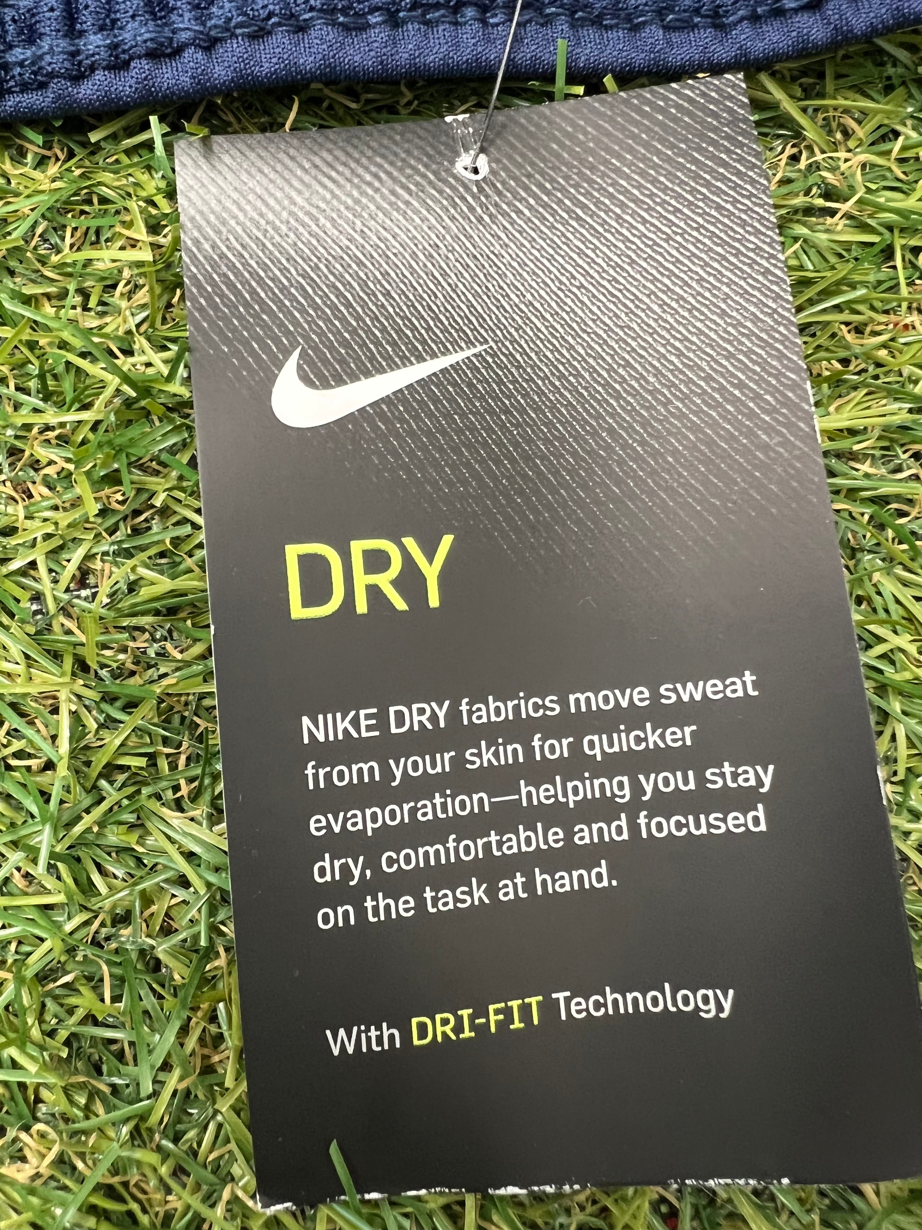 Close-up of Nike Dry Dri-FIT technology information tag on blue shorts