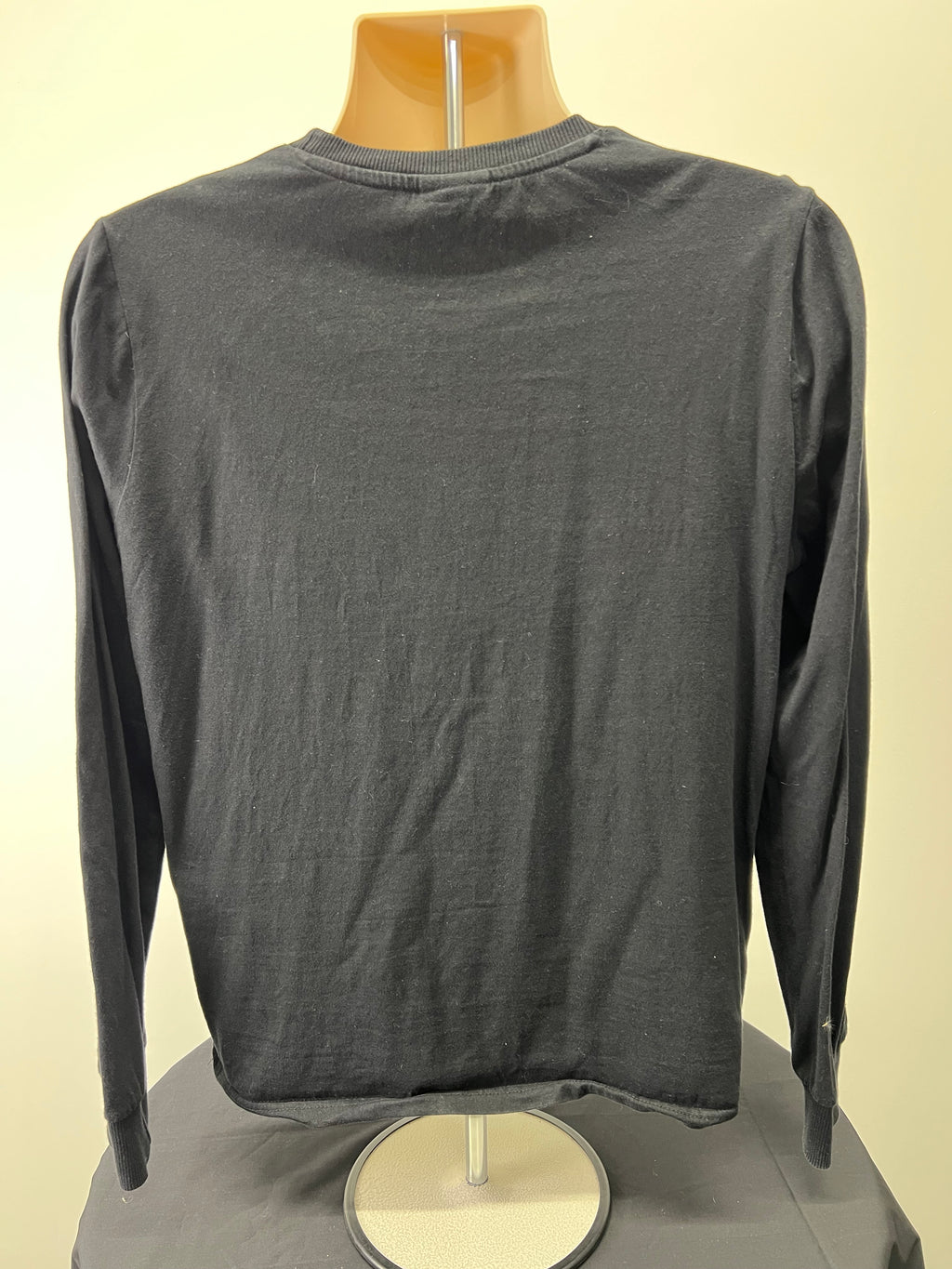 Back view of black ellesse women's long sleeve top showing plain fabric and ribbed cuffs