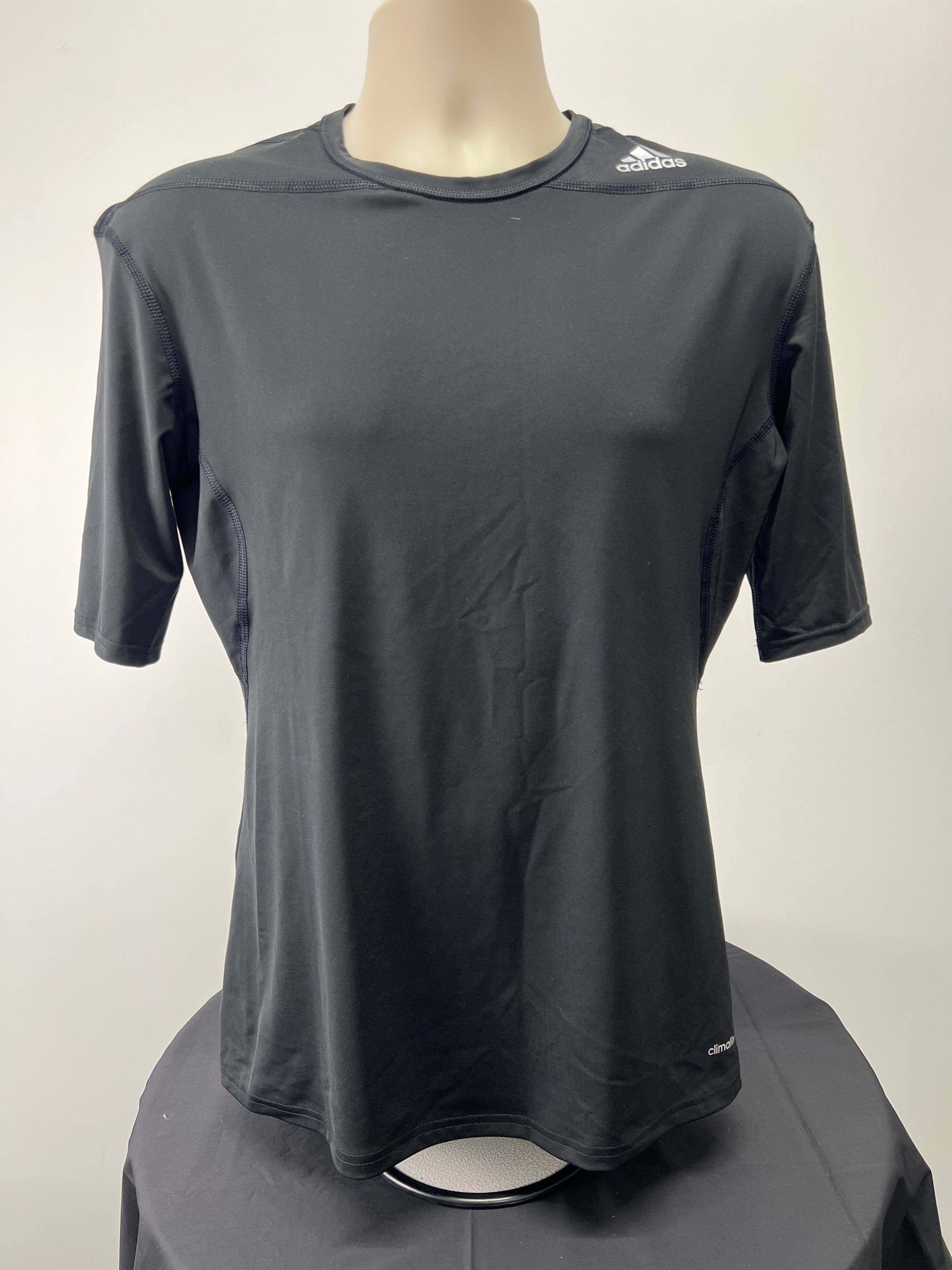 Front view of black Adidas Techfit compression short sleeve t-shirt on mannequin