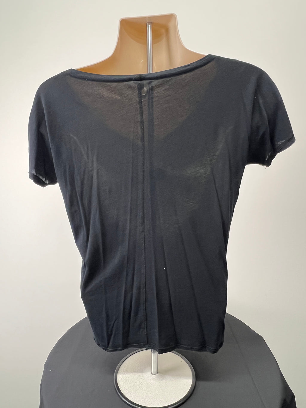 Back view of a black Sweaty Betty V-neck T-shirt on a mannequin showing a central seam