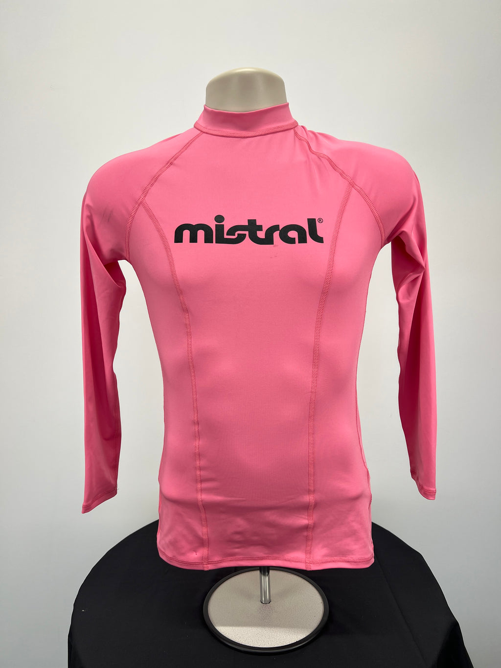 Front view of pink Ladies UV Rash Vest by Mistral with long sleeves and black logo