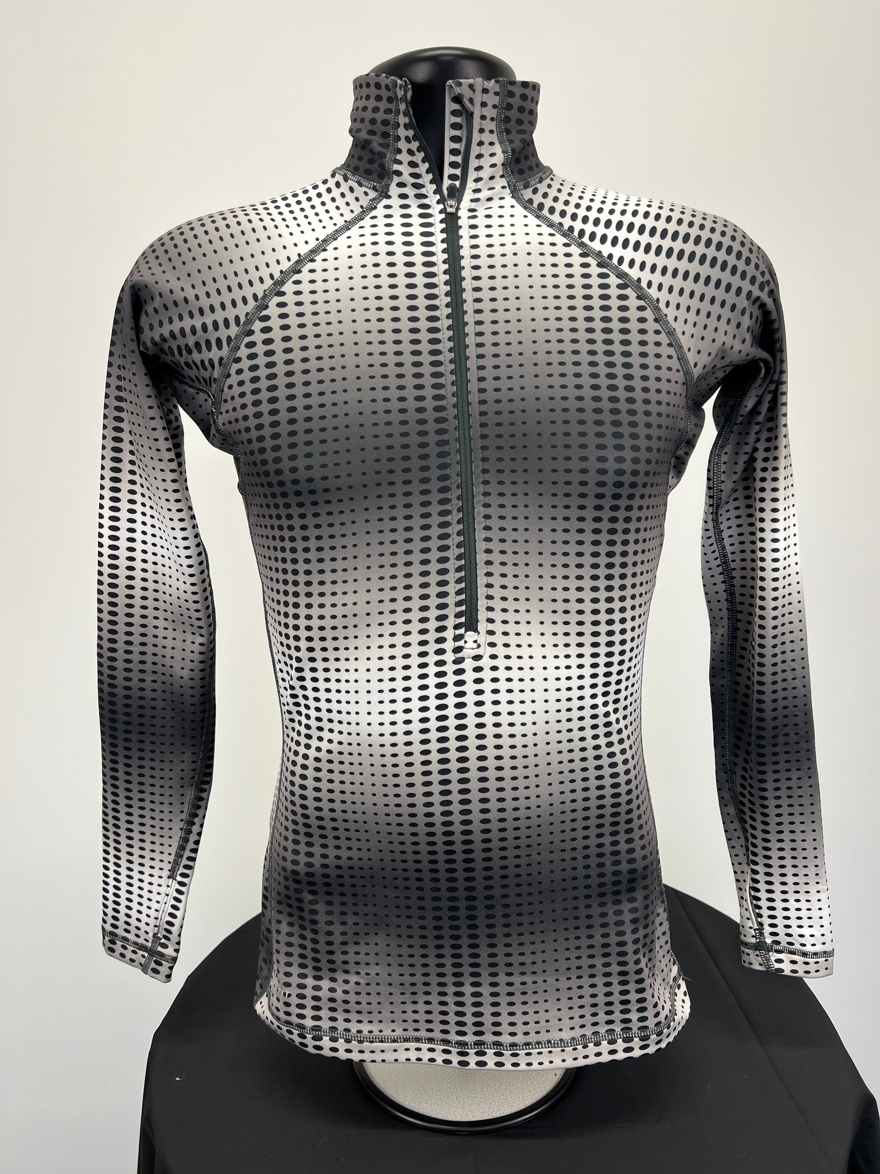 Front view of Nike Pro long sleeve top with black and white dotted gradient pattern and half zip