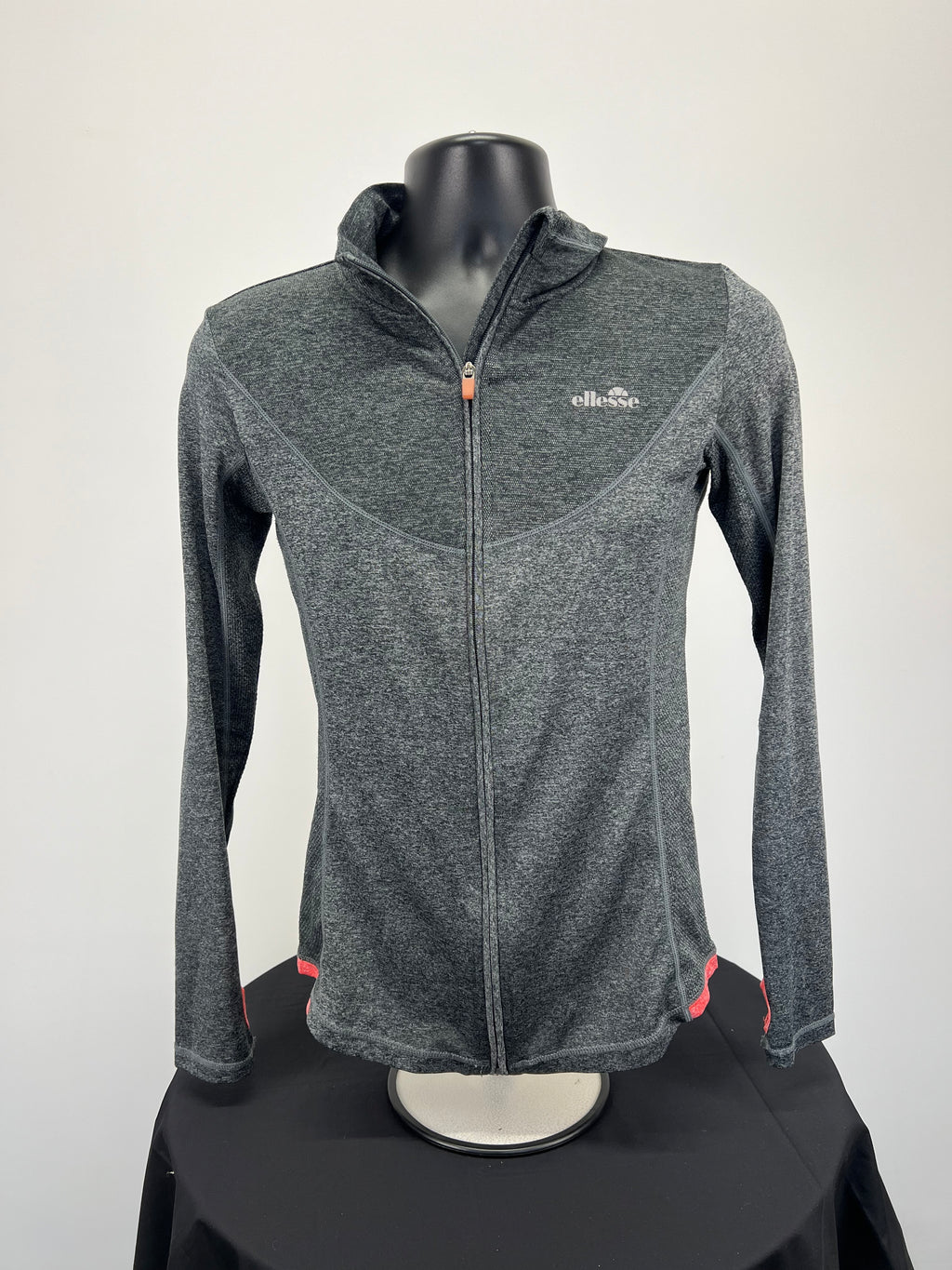 Front view of grey heathered Ellesse women’s full zip jacket with coral accents on mannequin