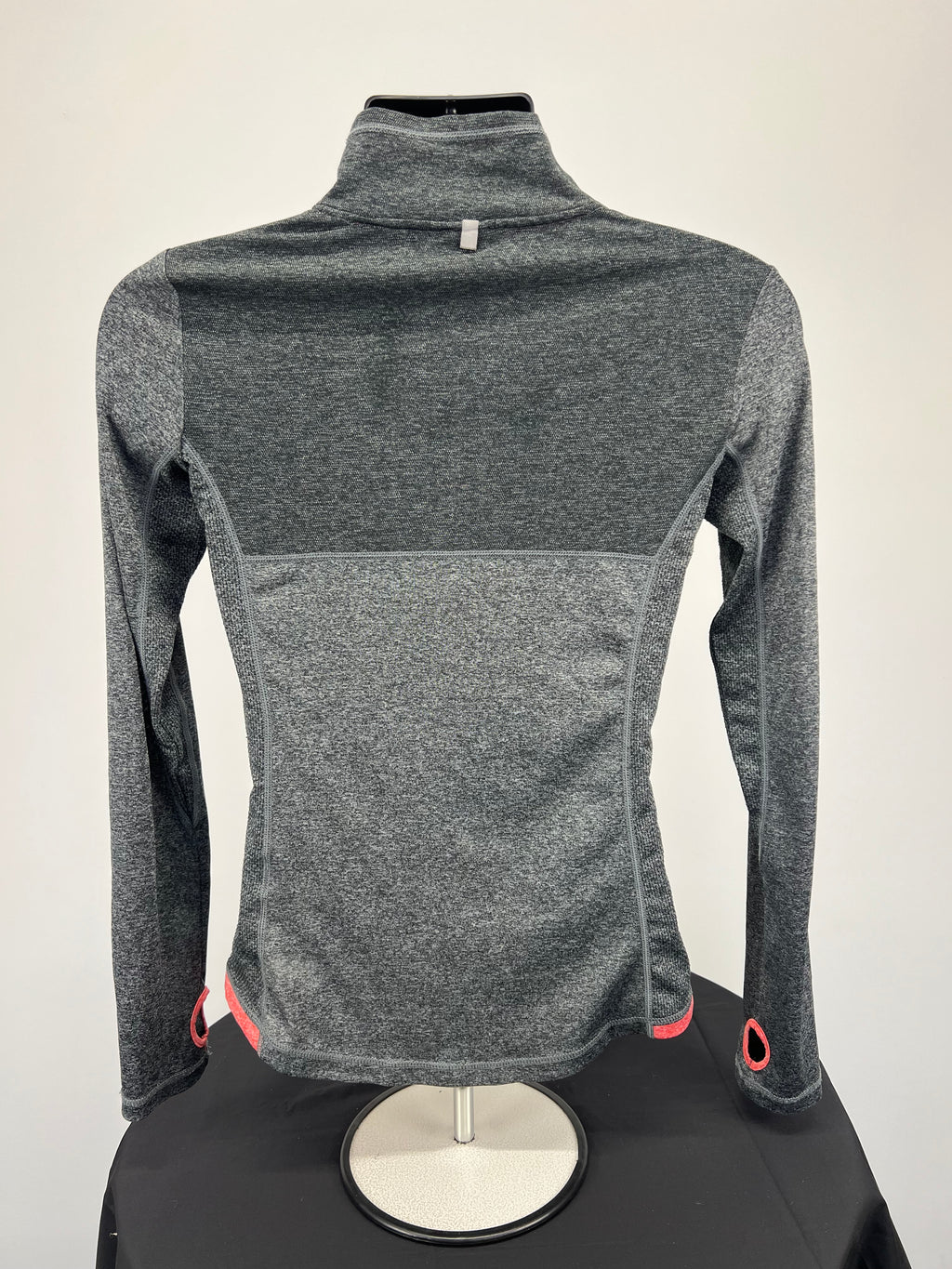 Back view of grey heathered Ellesse women’s full zip jacket showing long sleeves and thumb holes