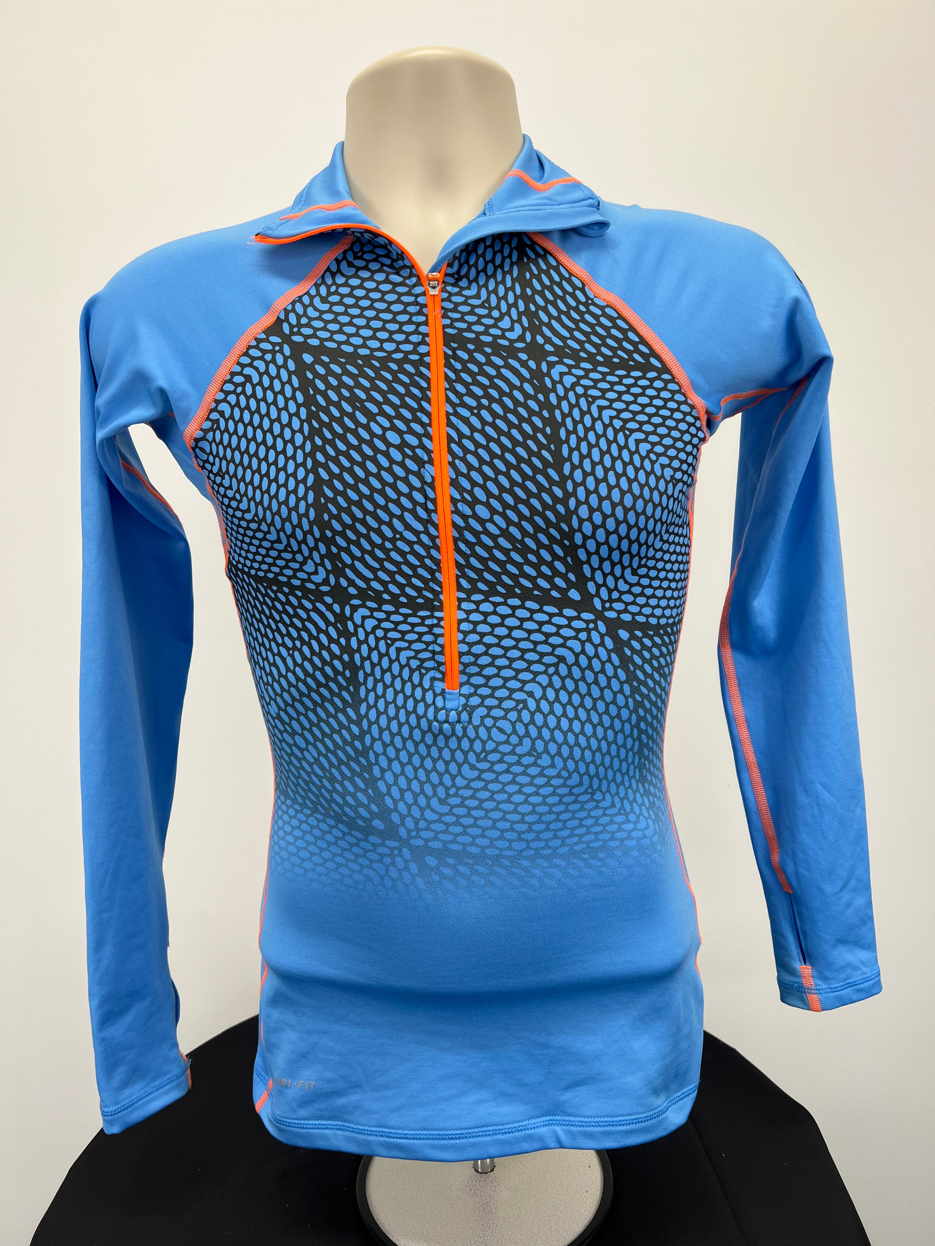 Front view of blue Nike Pro long sleeve half-zip top with orange zipper and black-blue patterned panel