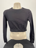 Front view of black Puma long sleeve crop top with breathable mesh fabric on mannequin