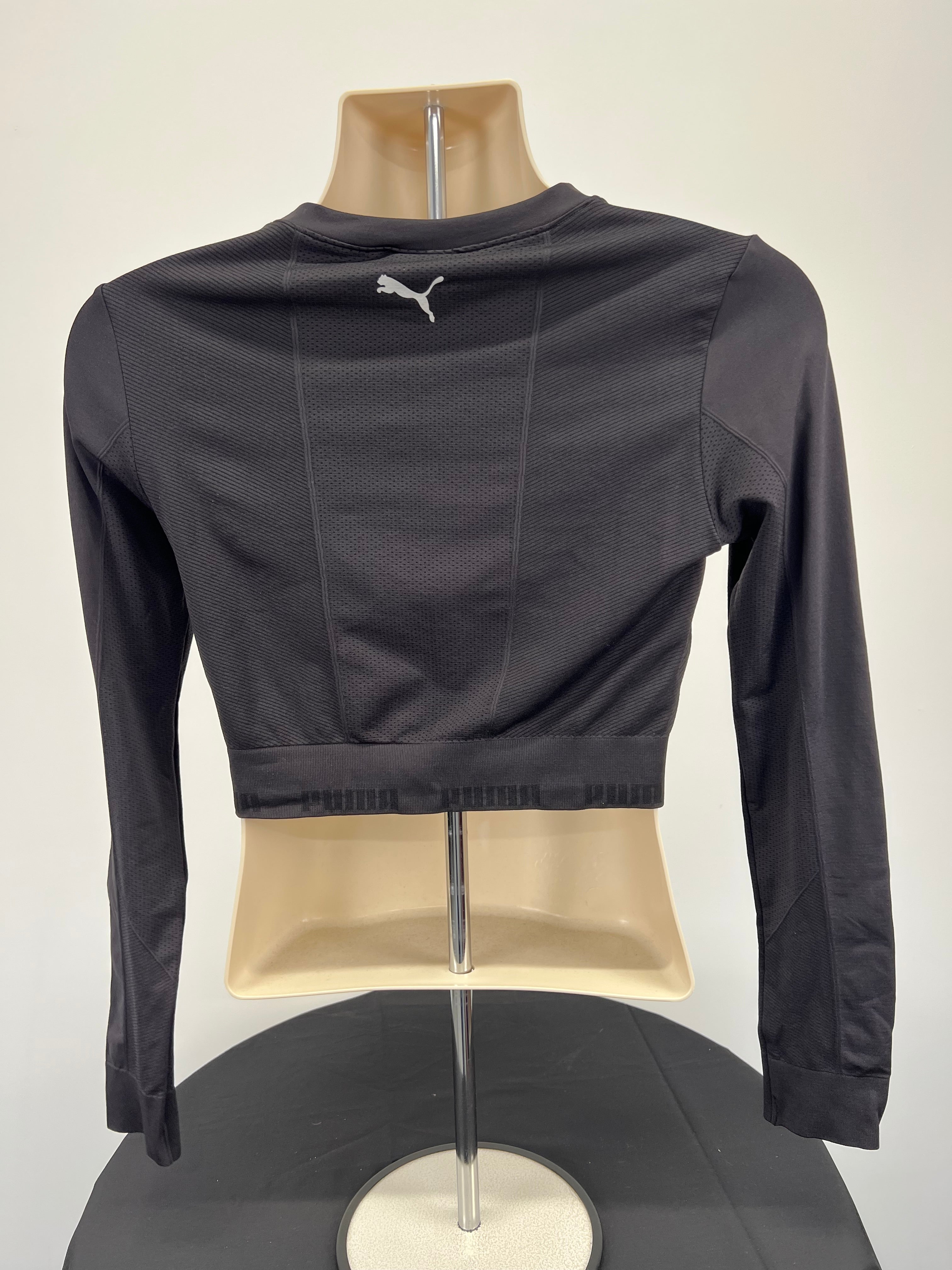 Back view of black Puma long sleeve crop top showing Puma logo on upper back and elastic branded hem