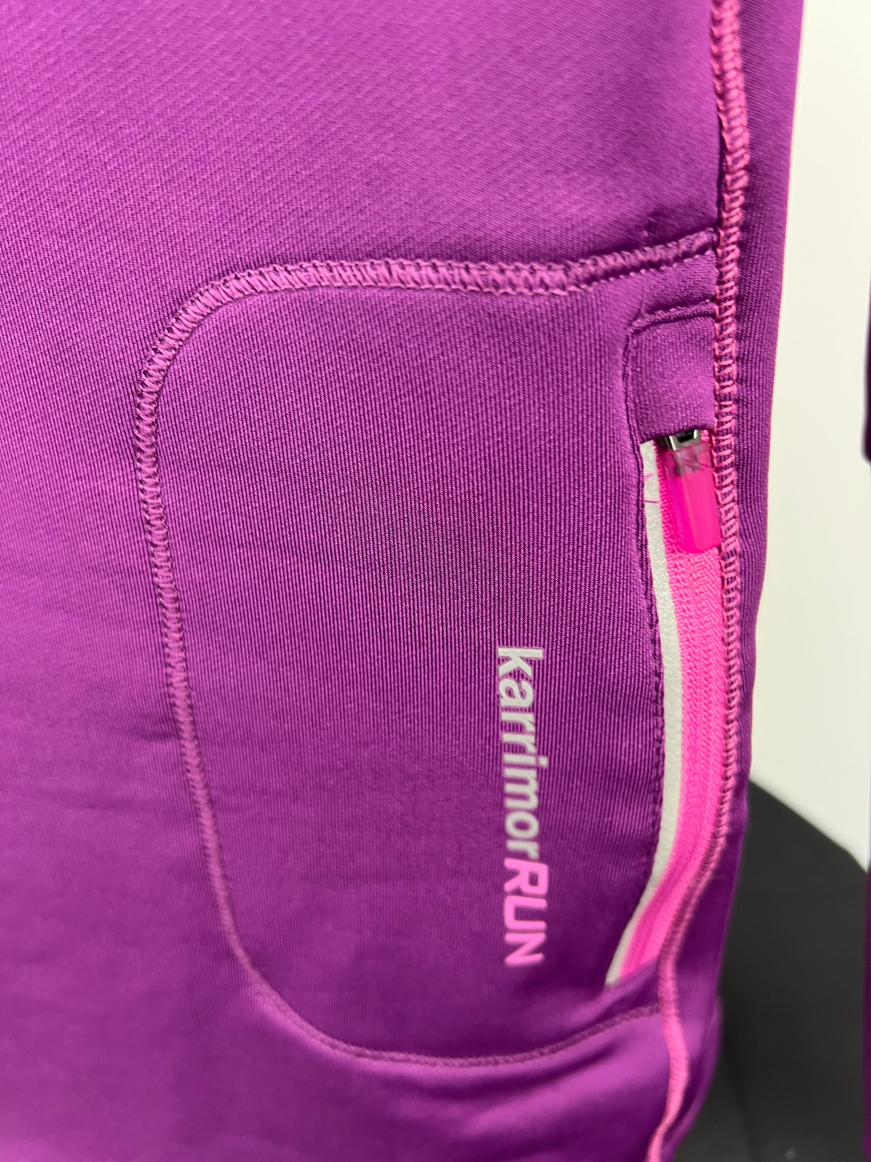 Close-up of zipped pocket on back of purple Karrimor Run women's long sleeve running top