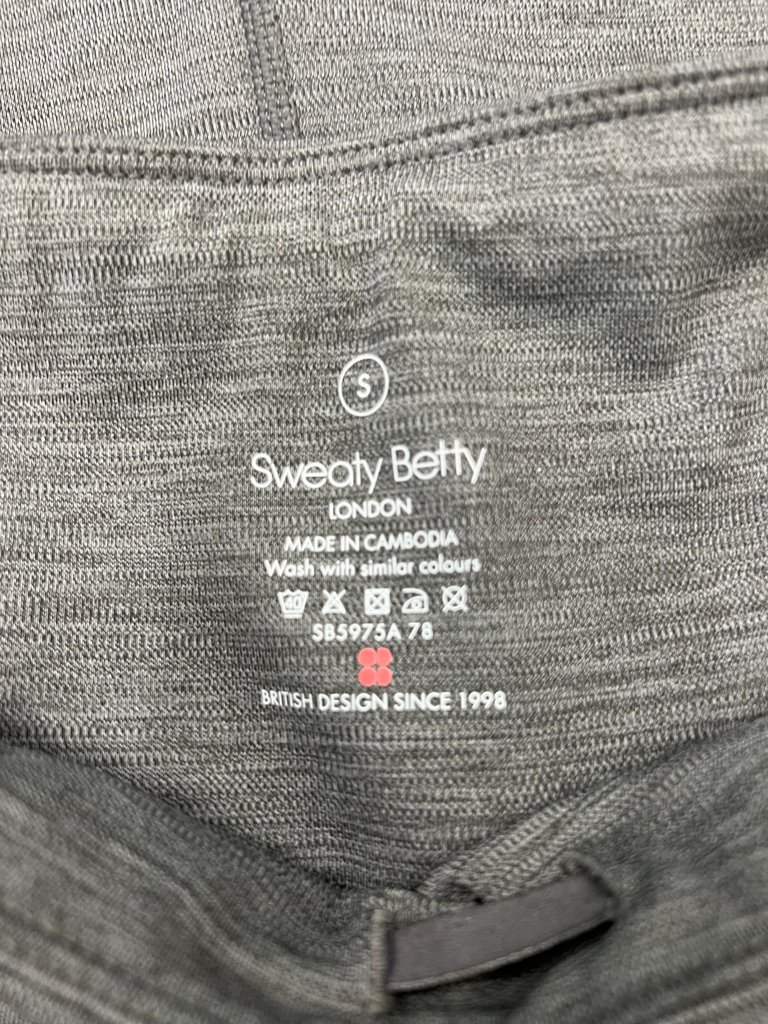 Close-up detail of Sweaty Betty label and care instructions inside the grey leggings