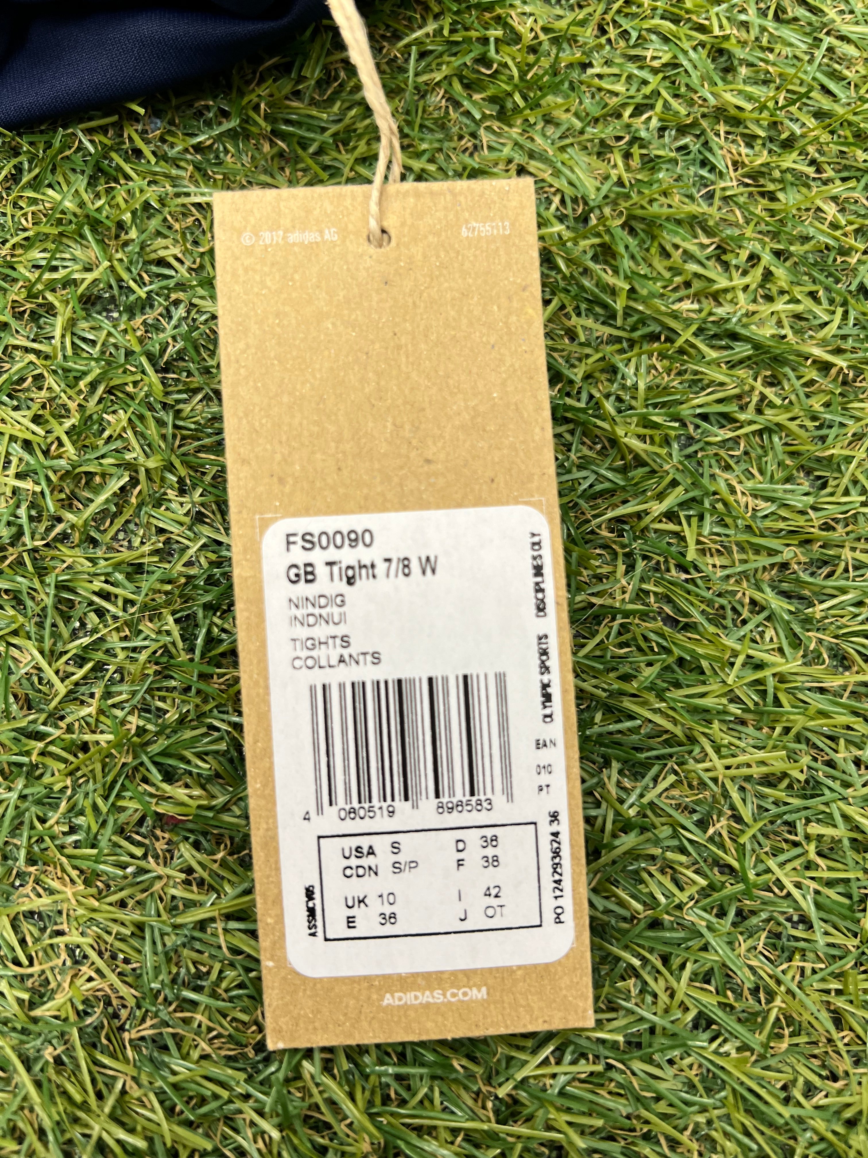 Close-up of cardboard product tag with Adidas branding and product details including size and barcode