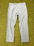 Front view of pale grey Sweaty Betty leggings with mesh inserts laid on grass