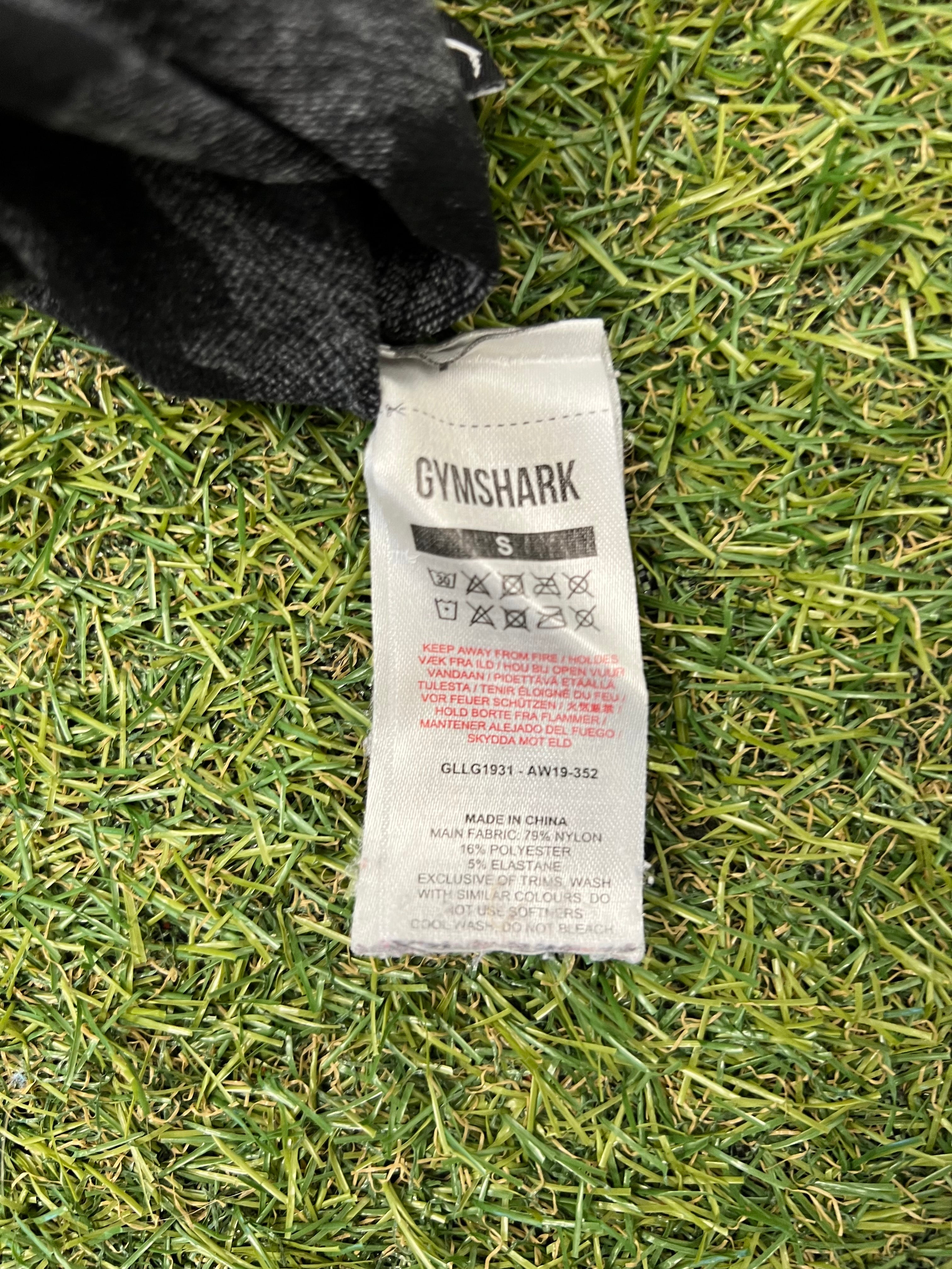 Close-up of fabric care label inside Gymshark active leggings detailing material composition and washing instructions