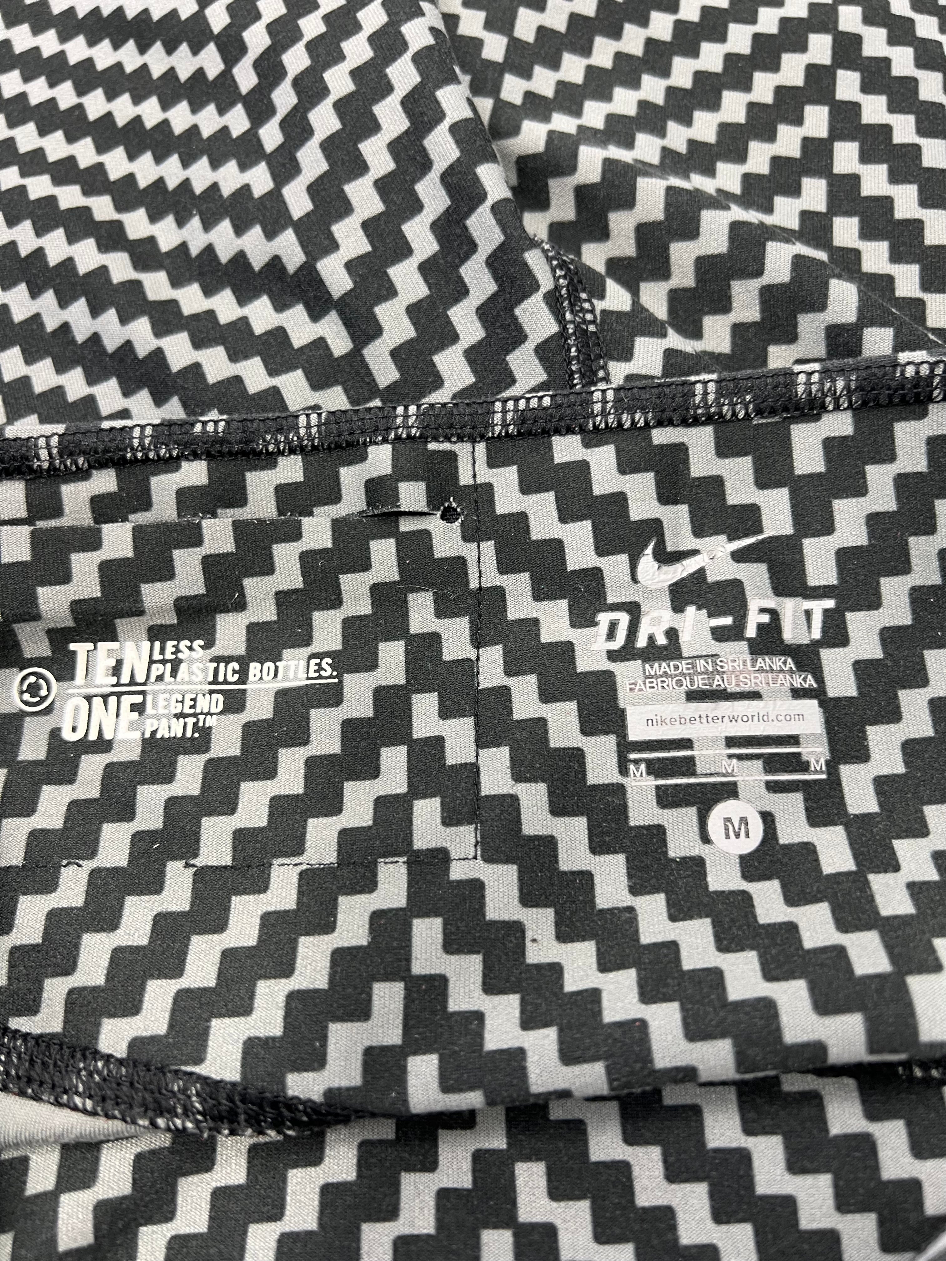Close-up of inner waistband showing Nike Dri-FIT logo and sustainable message about recycled plastic bottles
