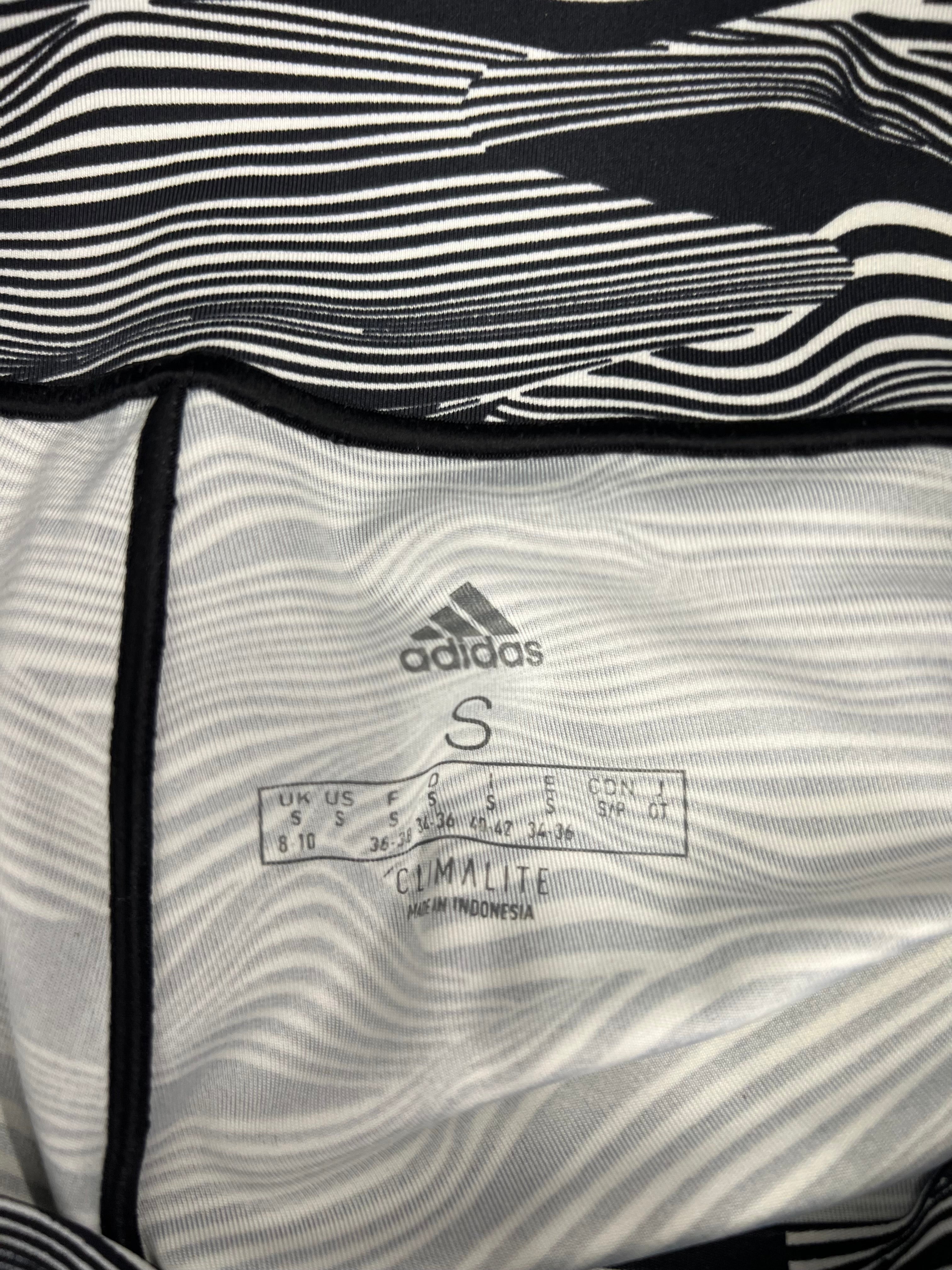 Close-up of interior tag inside Adidas leggings showing size S and Climacool fabric label
