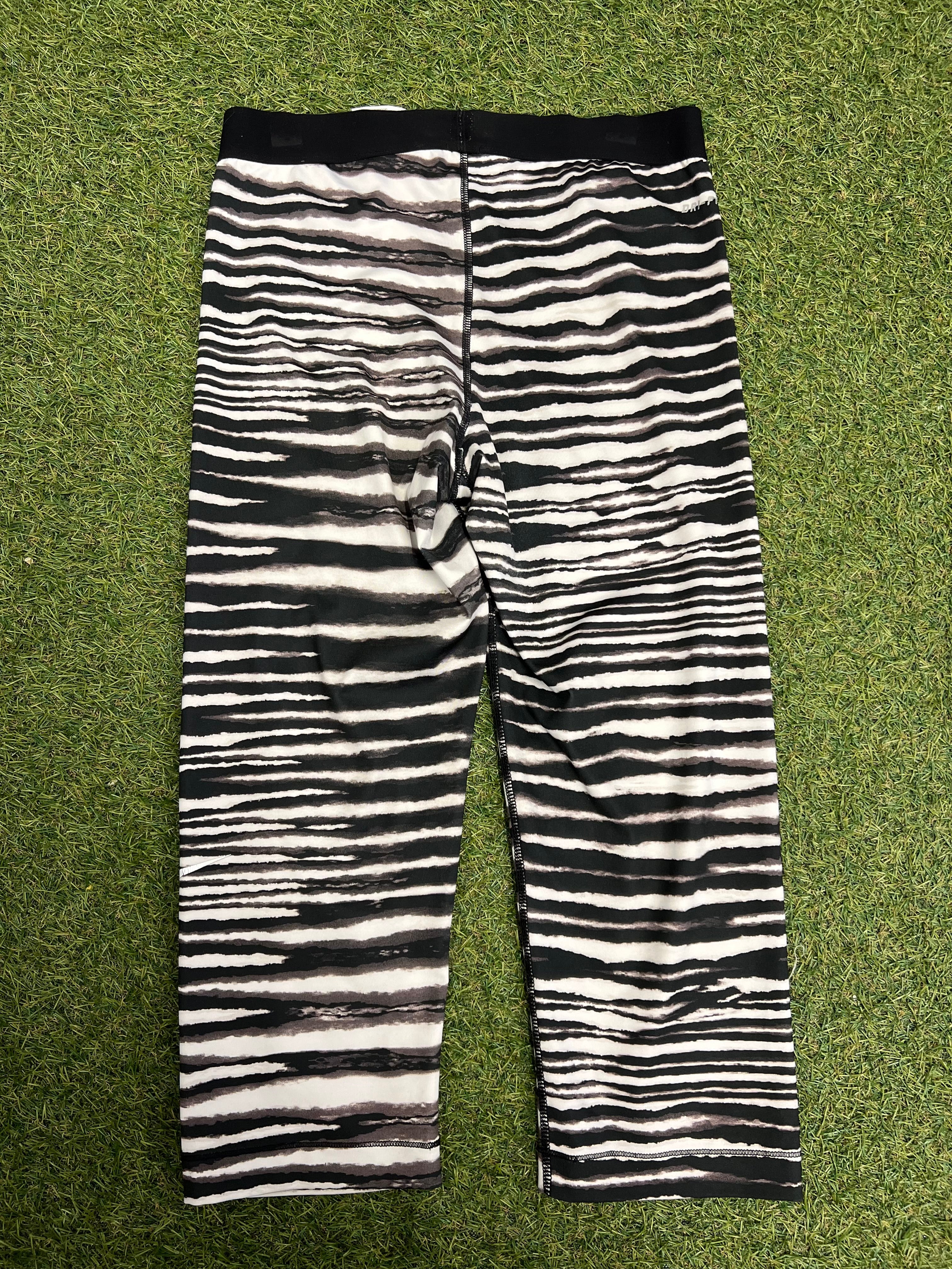 Rear view of black and white striped Nike Pro 7/8 leggings showing the design and fit
