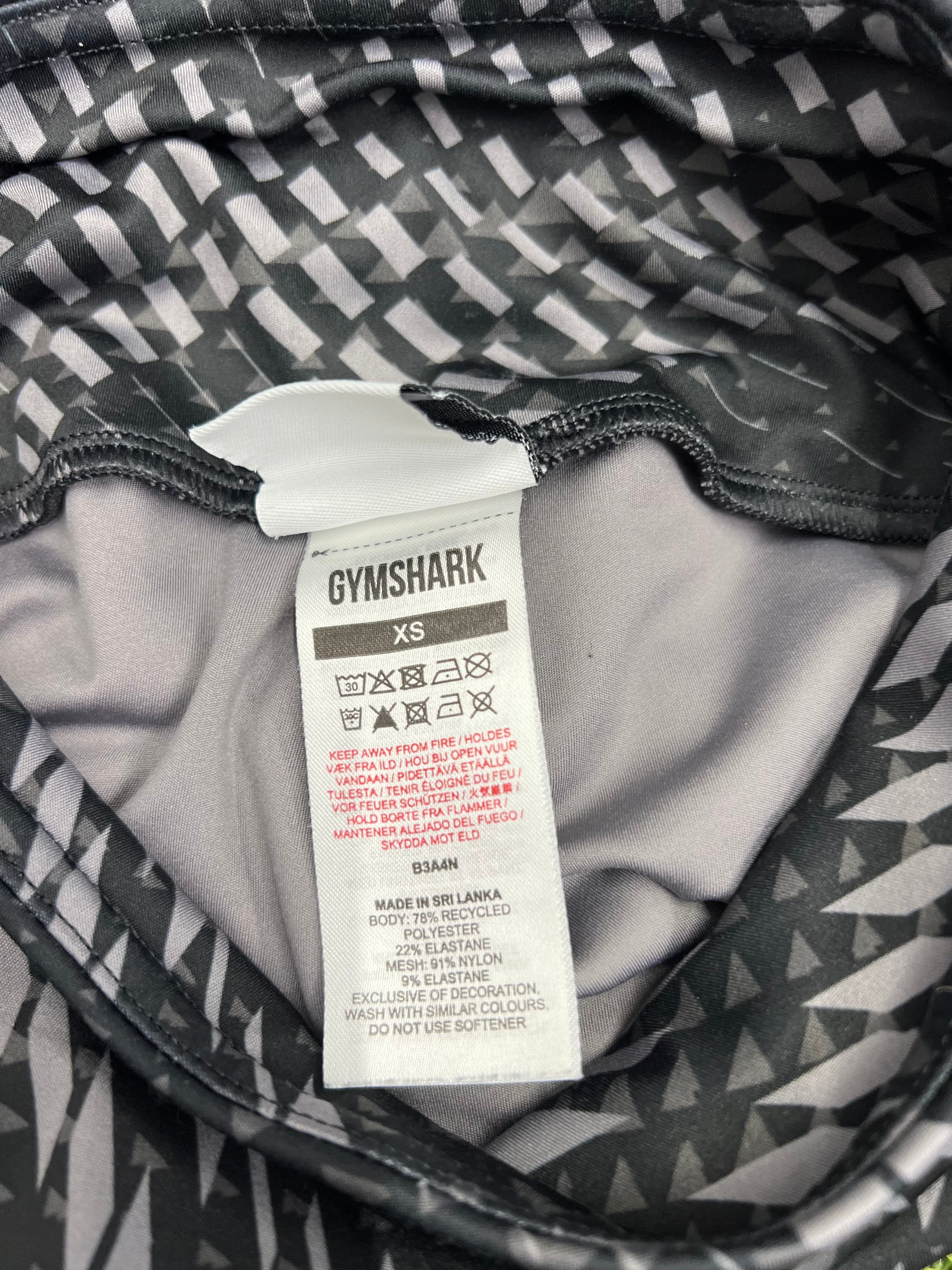 Close-up of Gymshark label showing size XS and fabric composition tag inside the leggings