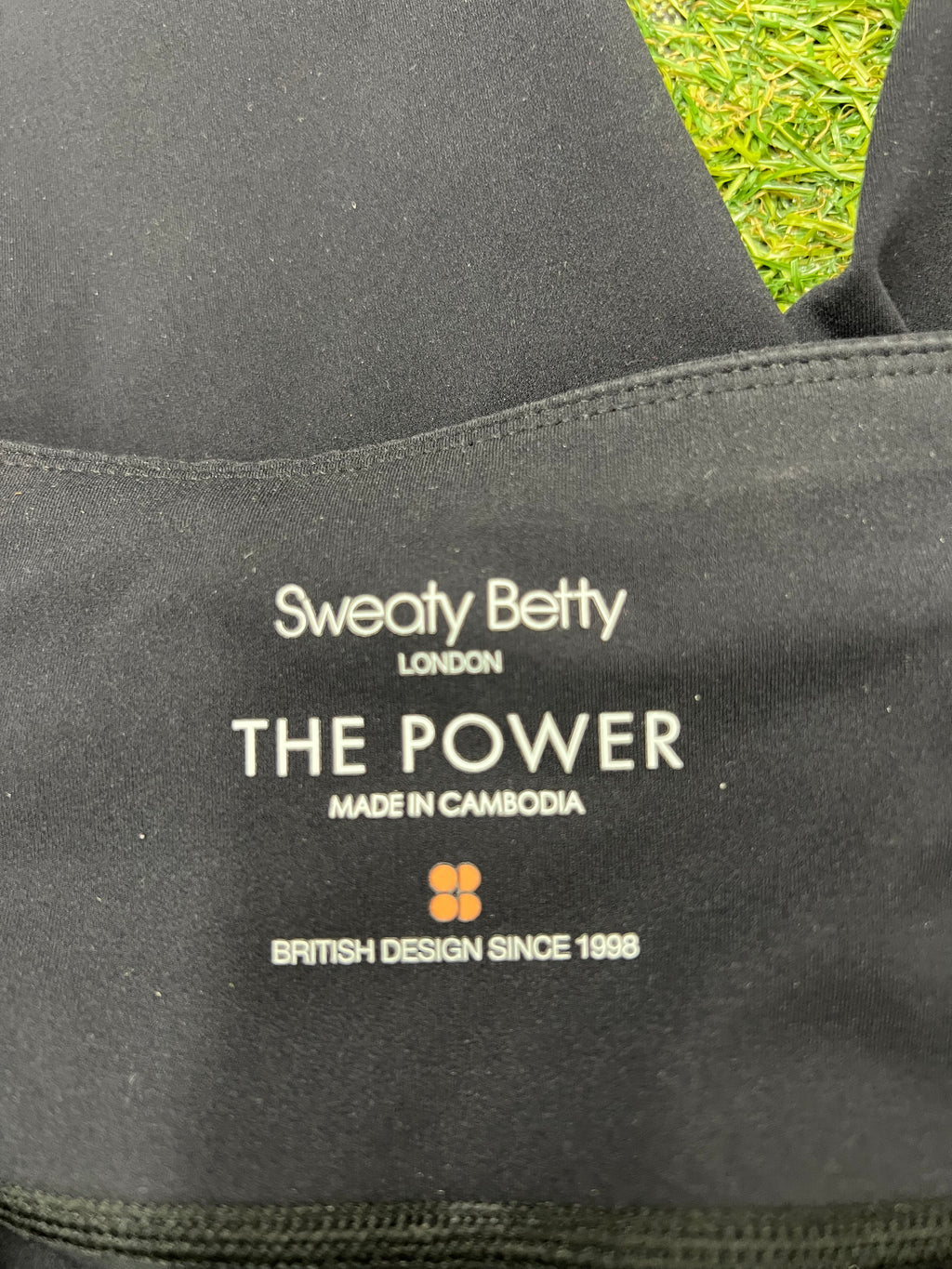 Close-up image of internal branding label inside waistband that reads Sweaty Betty London The Power made in Cambodia