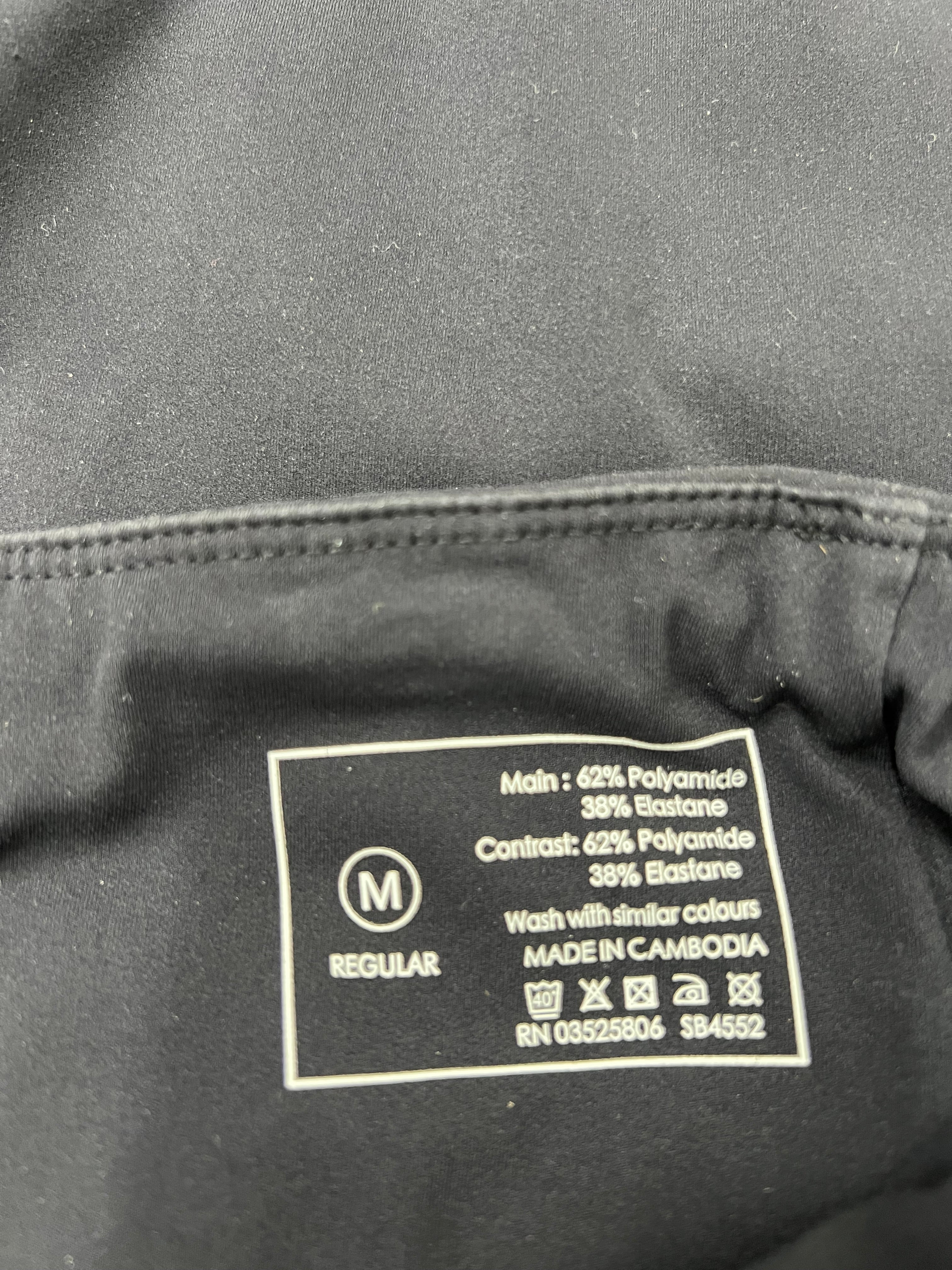 Close-up image of fabric care label showing material composition as 62% polyamide and 38% elastane with washing instructions