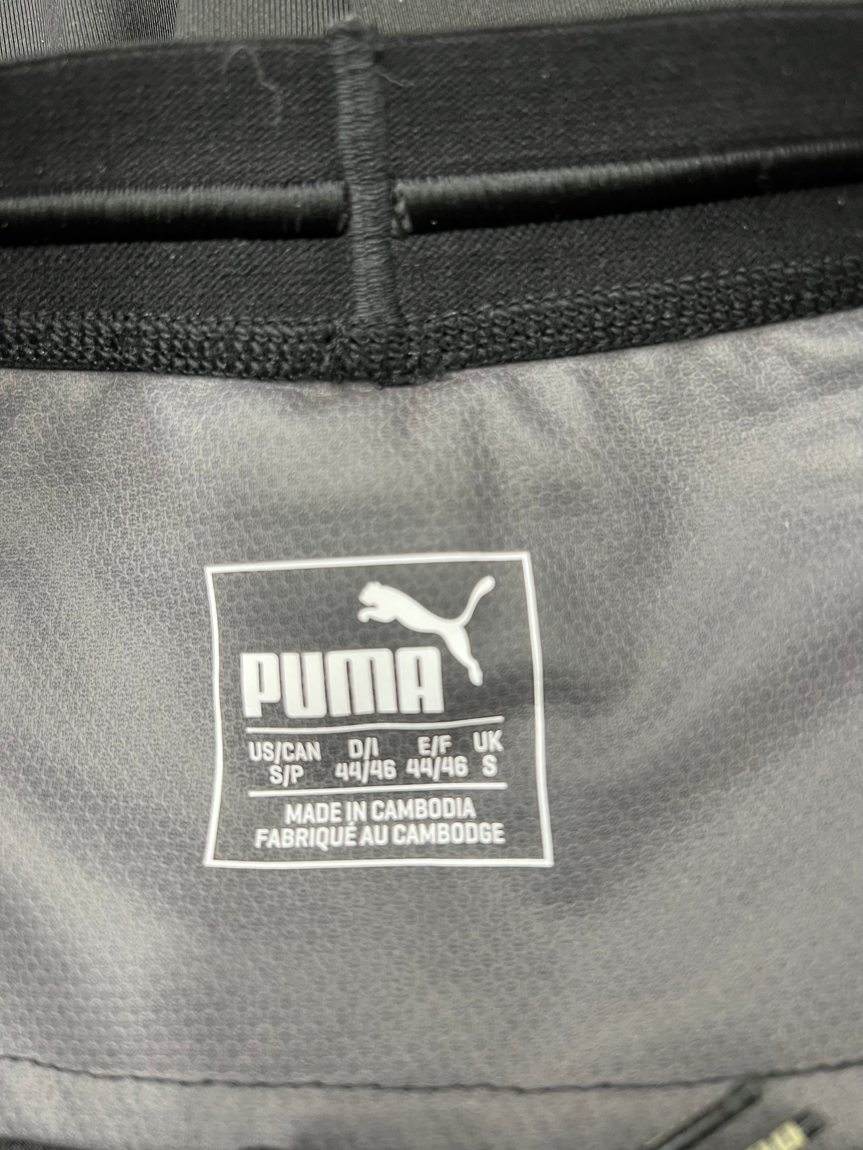 Close-up of inner waistband label showing Puma logo and size details on black leggings
