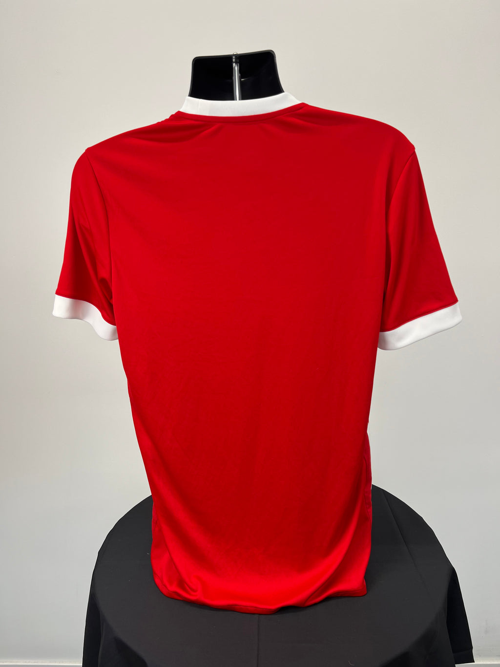 Back view of red Middlesbrough FC football shirt showing plain red design with white sleeve cuffs