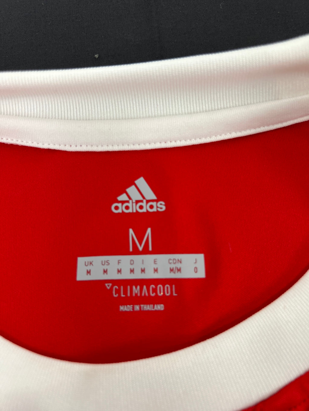 Interior collar label of Adidas Climacool Middlesbrough FC football shirt showing size M and made in Thailand