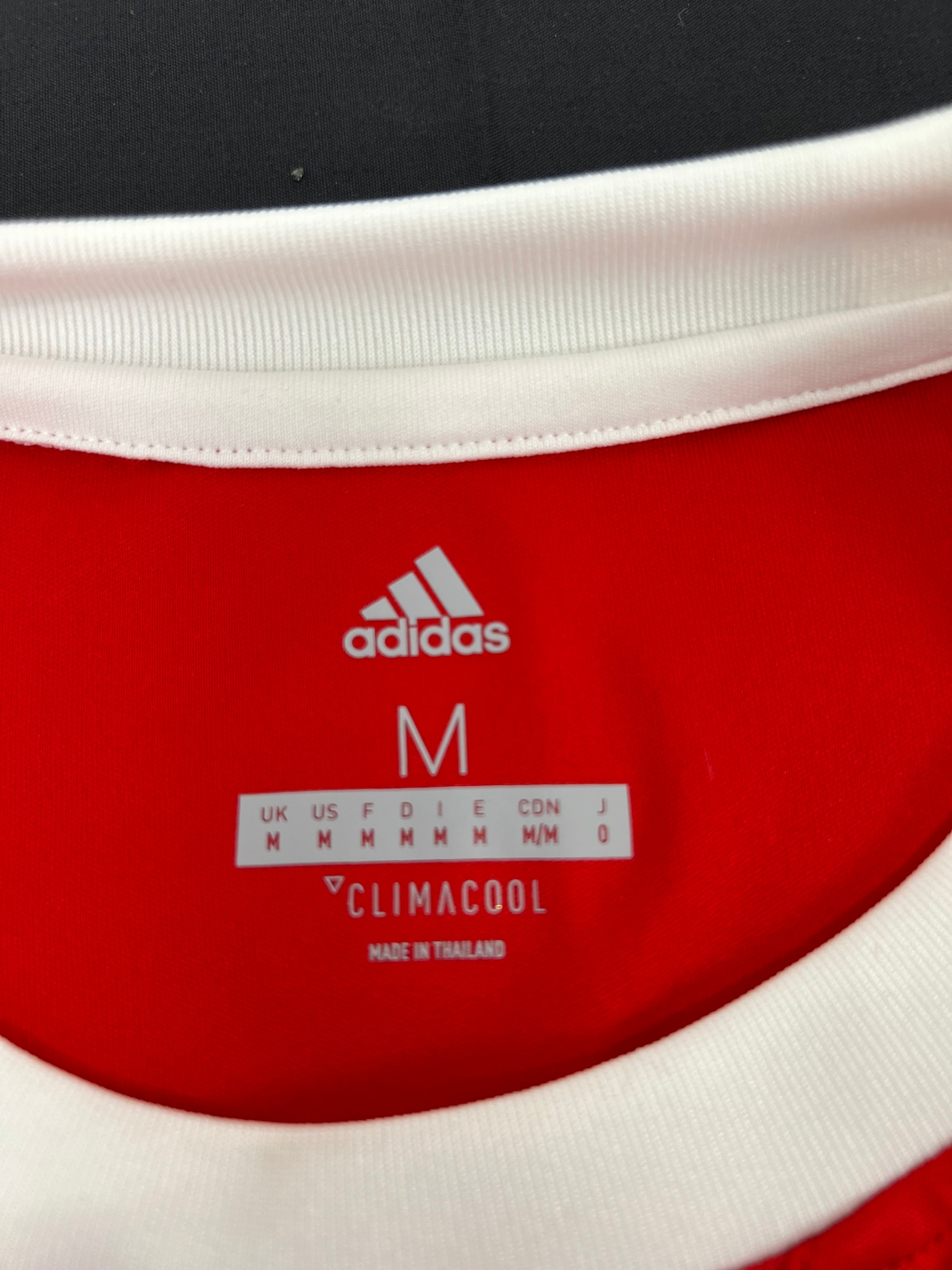 Interior collar label of Adidas Climacool Middlesbrough FC football shirt showing size M and made in Thailand
