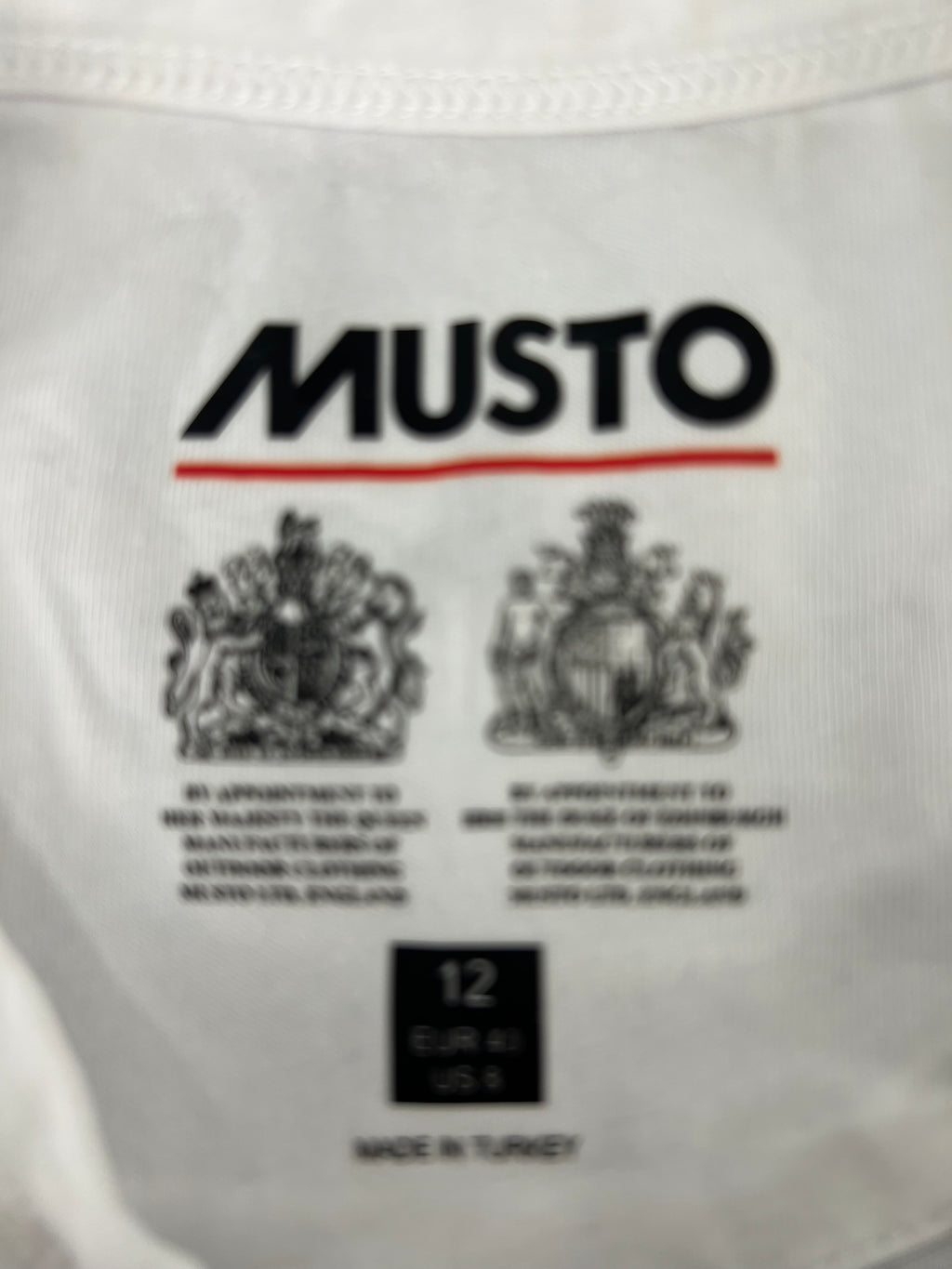 Close-up of Musto label inside T-shirt showing size 12 and origin made in Turkey