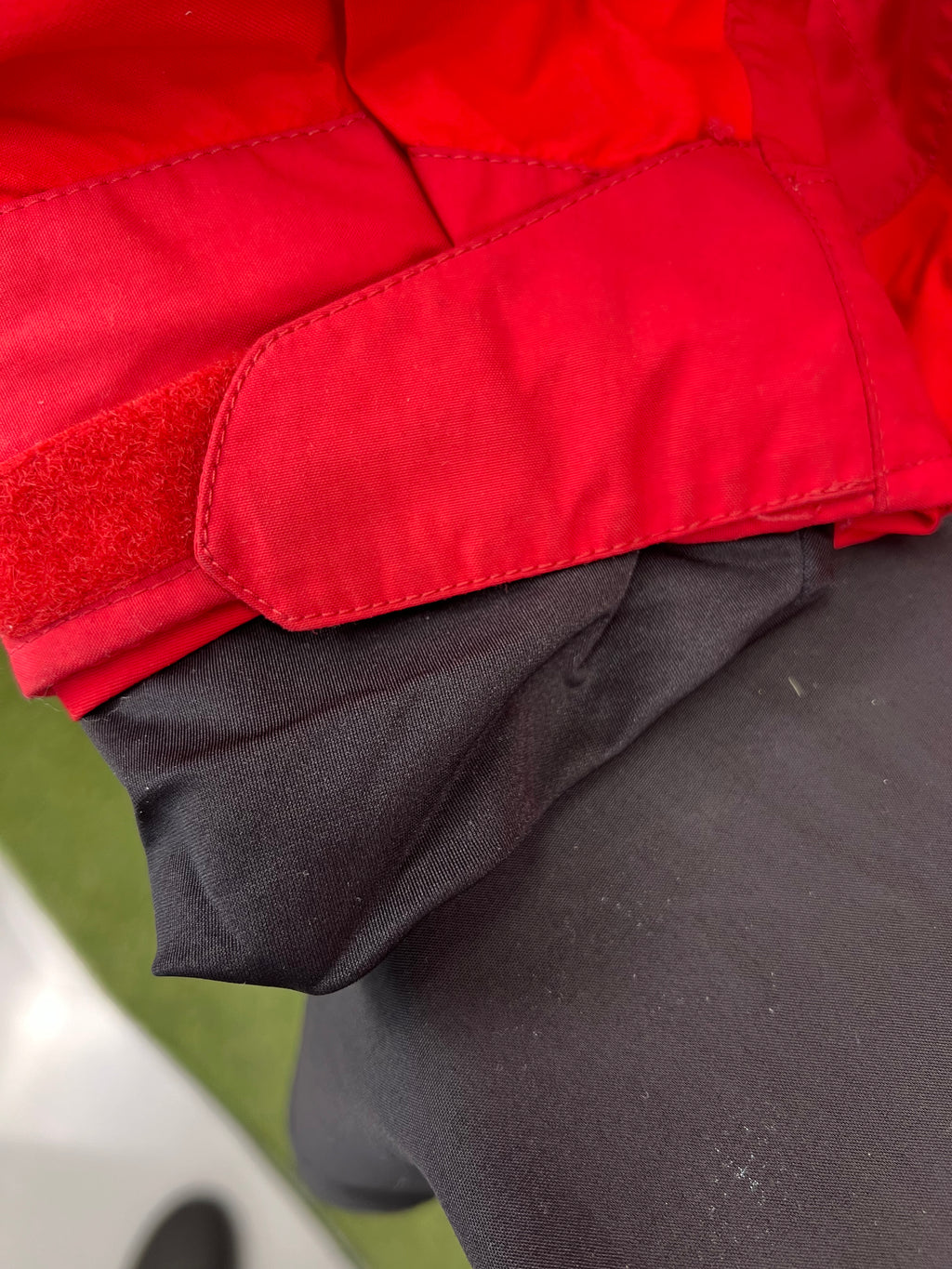 Close-up of adjustable Velcro cuff on red Eider jacket sleeve