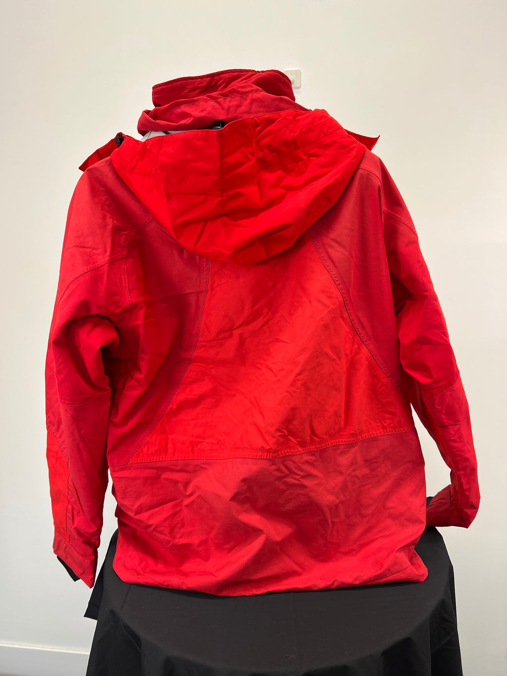 Back view of red Eider men's ski jacket showing hood and seam details