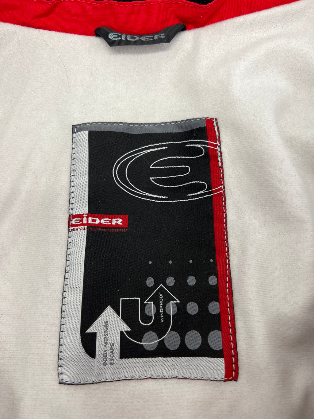 Inner label of red Eider jacket showing brand logo and Gore-Tex material information