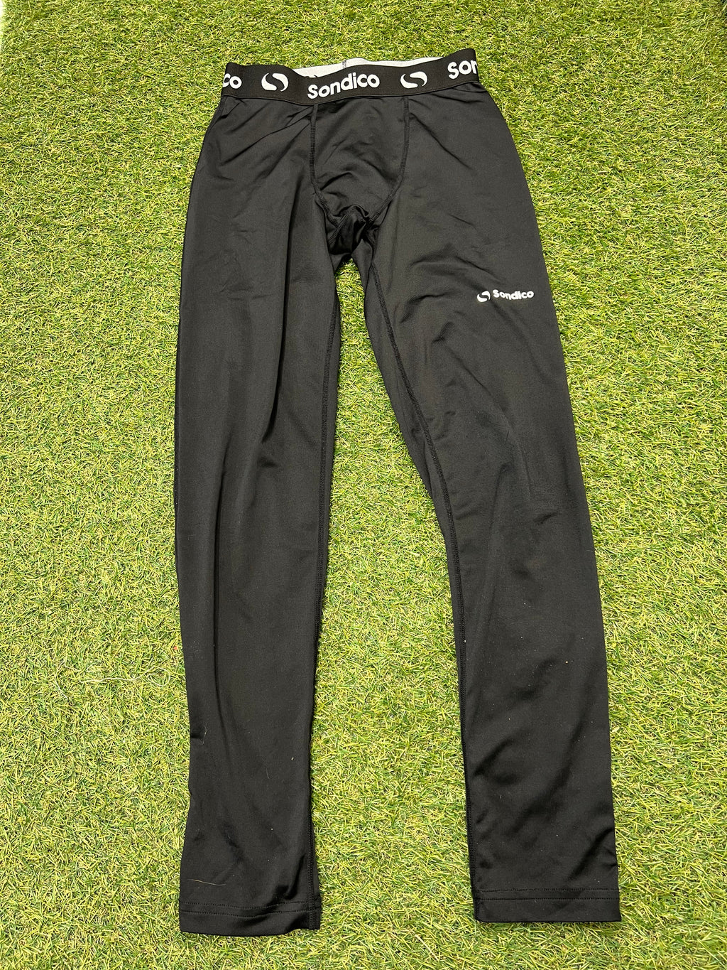 Front view of black Sondico kids base layer leggings showing elastic waistband with logo
