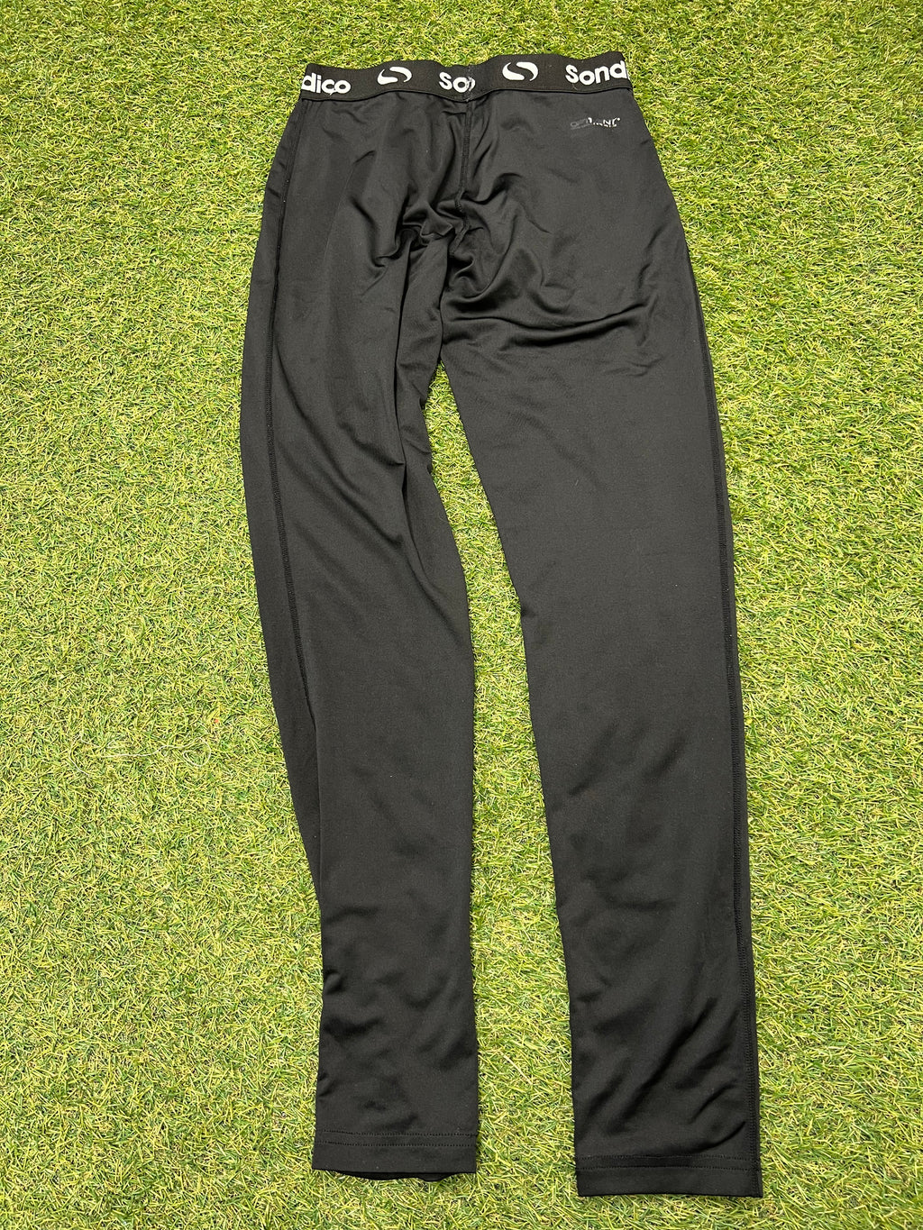 Back view of black Sondico kids base layer leggings showing smooth fabric and stitching