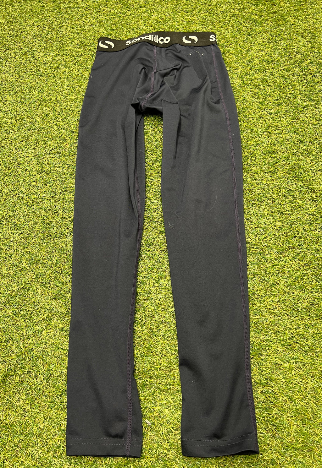 Close-up of Sondico logo label inside black leggings waistband indicating size 9-10 years
