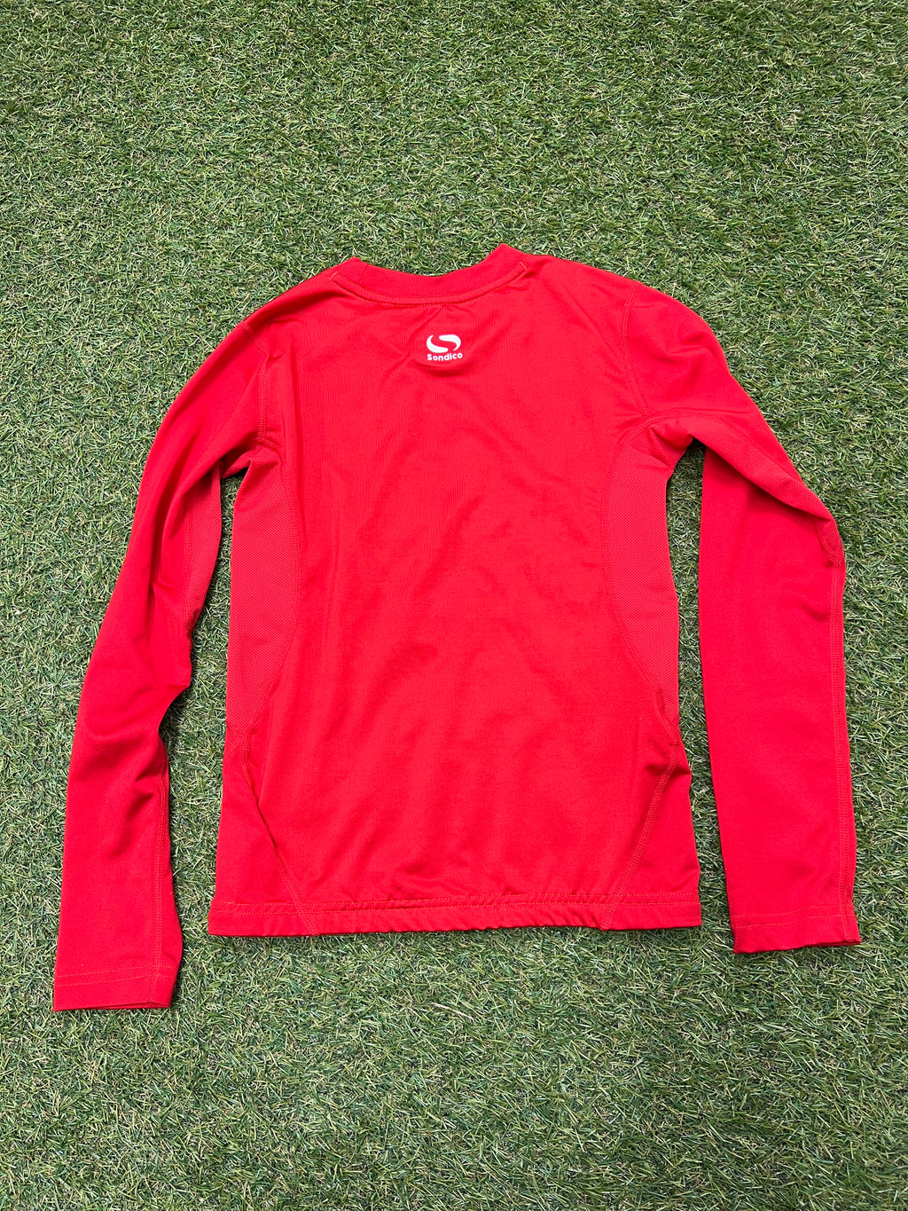 Close-up of the red top showing neckline and internal size label for 9-10 years