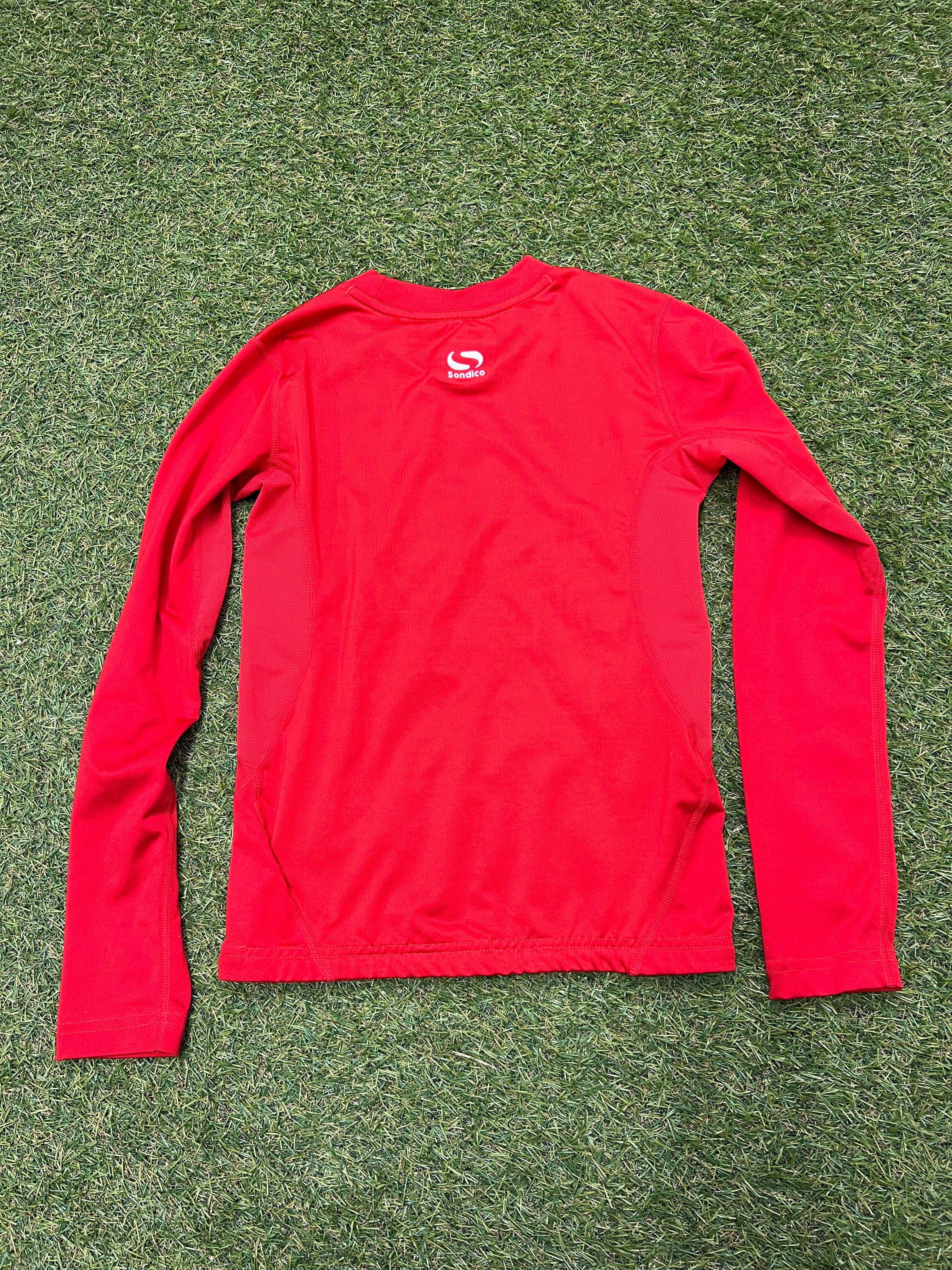 Close-up of the red top showing neckline and internal size label for 9-10 years